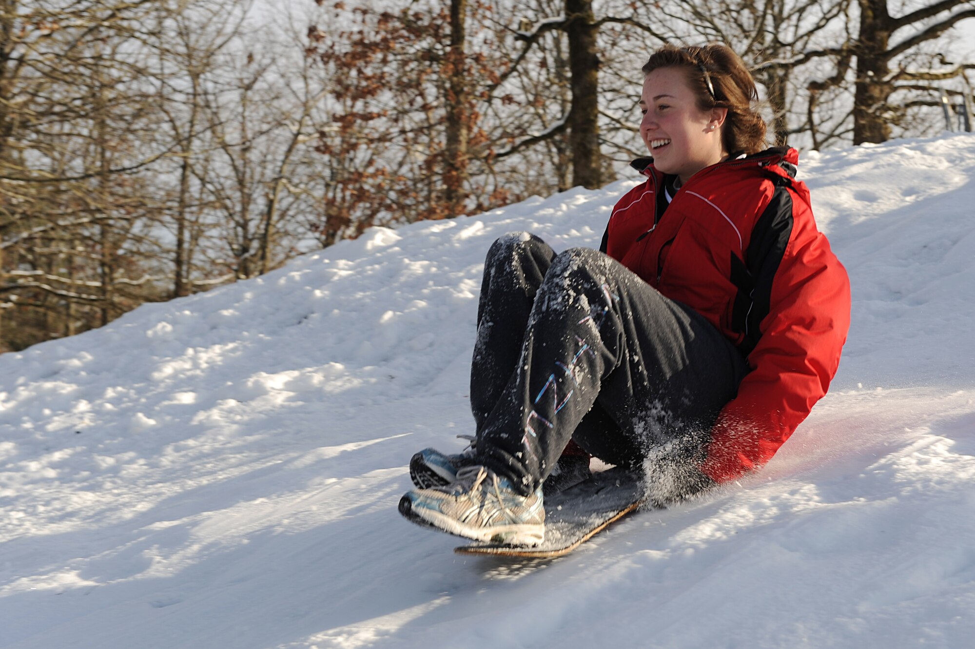 Shelby Robinson, daughter of Lt. Col. Scott Robinson, 62nd Airlift Squadron director of operations, slides down a snow-covered hill Feb. 10. Heavy snow fall for the Little Rock AFB area resulted in the closure of local schools giving children in base housing the opportunity to enjoy the winter snow fall.  (U.S. Air Force photo by Staff Sgt. Chad Chisholm)