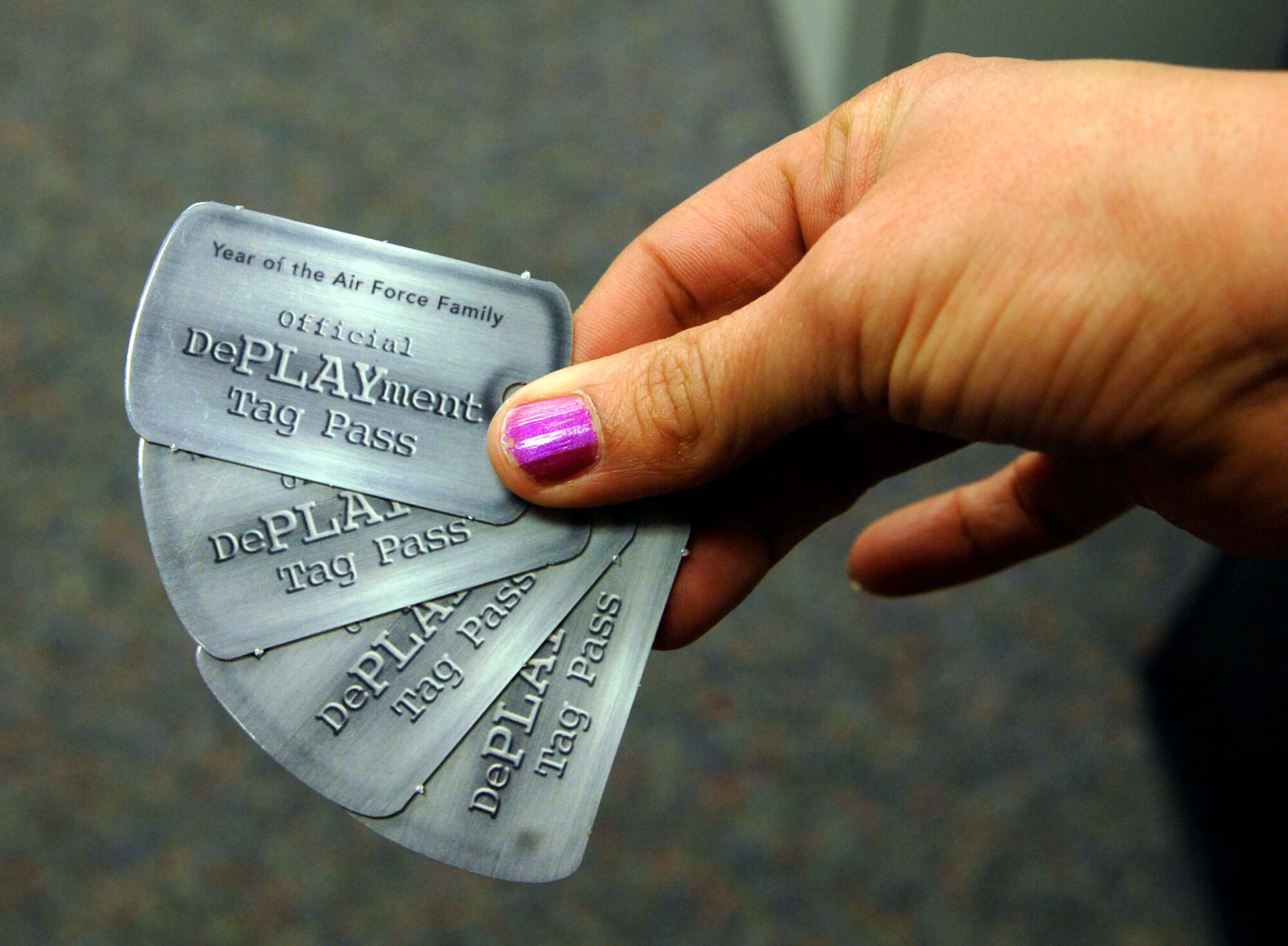 The Airman Family and Readiness Center is offering DePLAYment tags to families of Airmen who deployed or will deploy from July 2009 to July 2010, as part of the Year of the Air Force Family. The families can use the tags to receive reduced fees or free access to fitness classes, bowling games, hourly childcare and other family programs at McConnell. (U.S. Air Force photo/Senior Airman Abigail Klein)

