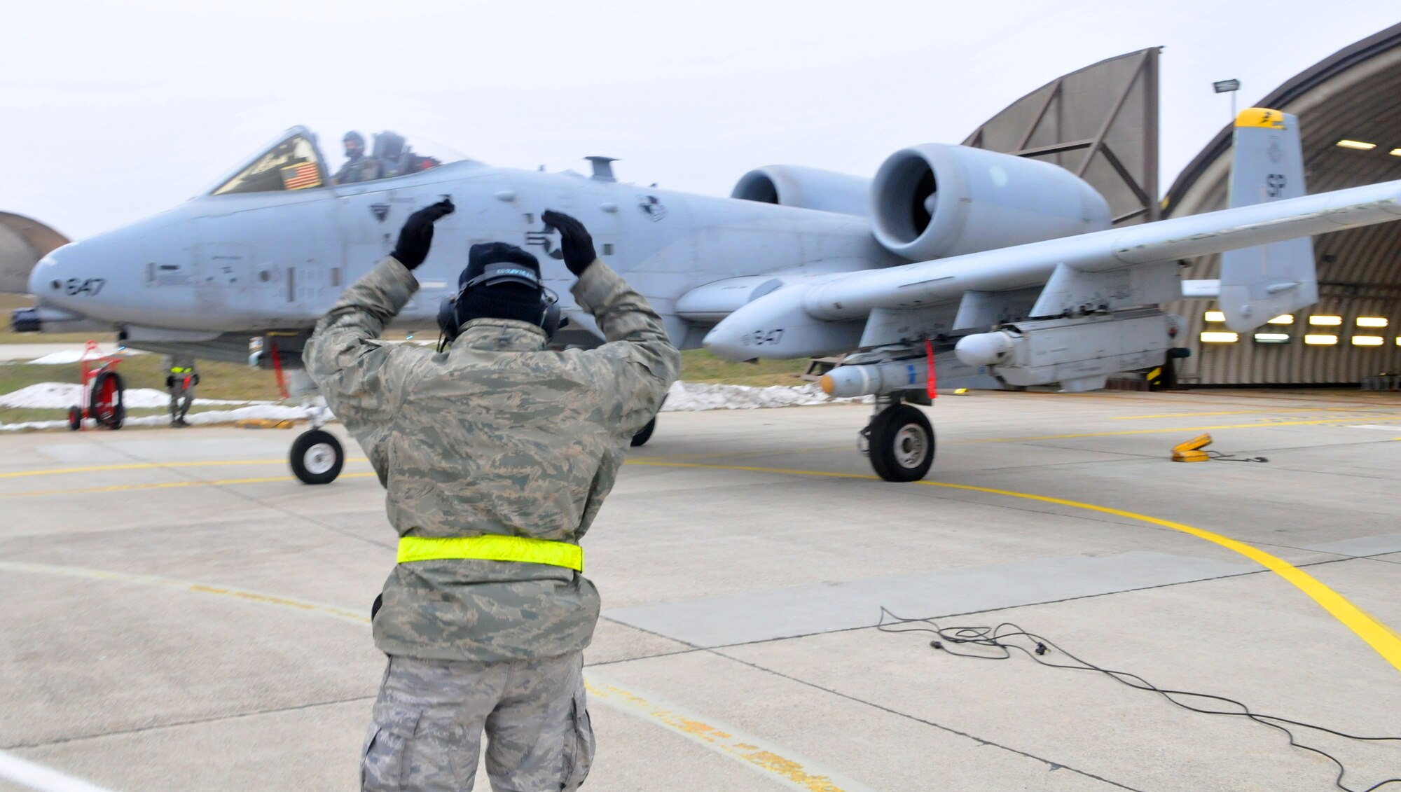 SPANGDAHLEM AIR BASE, Germany -- Airman 1st Class Savon Scales, 52nd Aircraft Maintenance Squadron crew chief, marshalls an A-10 Thunderbolt II prior to launch Feb. 9 on the flightline. (U.S. Air Force photo/Airman 1st Class Nick Wilson) 