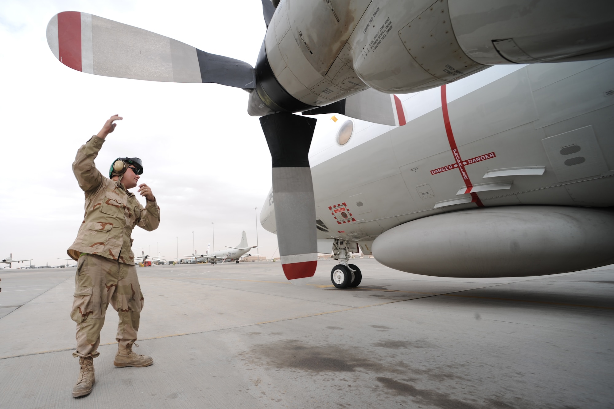 Navy Petty Officer 1st Class Joshua Gerke, Combined Task Group 57.1 aviation machinist, performs a pre-flight prop inspection on an EP-3 reconaissance aircraft at a non-disclosed Southwest Asia location, Feb. 6, 2010. (U.S. Air Force photo by Tech. Sgt. Michelle Larche)[RELEASED]
