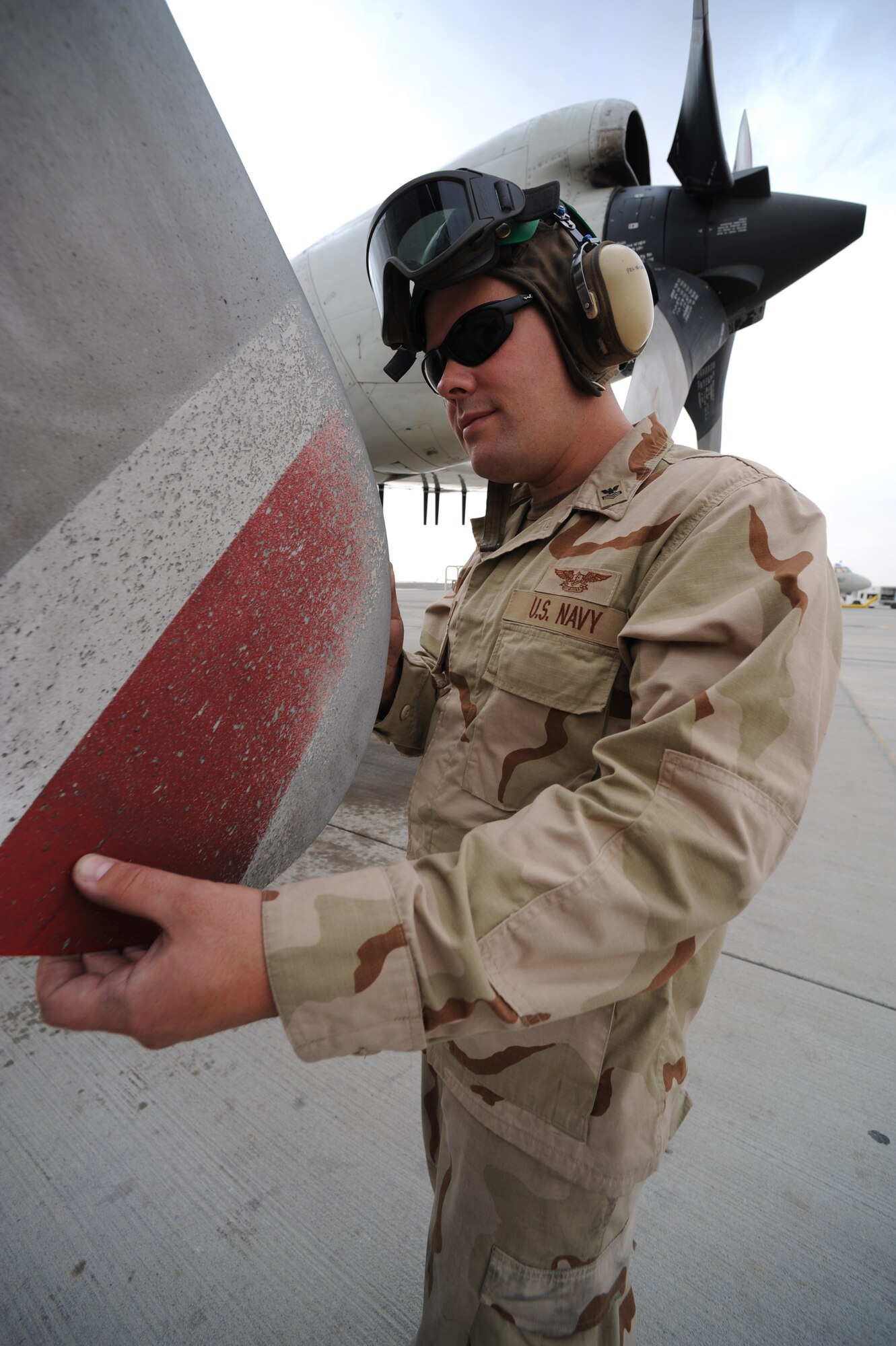 Navy Petty Officer 1st Class Joshua Gerke, Combined Task Group 57.1 aviation machinist, performs a pre-flight prop inspection on an EP-3 reconaissance aircraft at a non-disclosed Southwest Asia location, Feb. 6, 2010. (U.S. Air Force photo by Tech. Sgt. Michelle Larche)[RELEASED]
