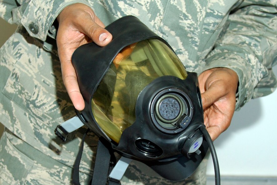 Tech. Sgt. Thomas Cyphers, a 22nd Civil Engineer Squadron emergency management training NCOIC, demonstrates how to assemble a gas mask during a survival skills training class in building 9, Jan. 26, 2010, at McConnell Air Force Base, Kan. EM instructors prepare Airmen for deployments by teaching them essential response skills for a potential chemical and biological attack. (U.S. Air Force photo/Staff Sgt. Anthony Mejia)