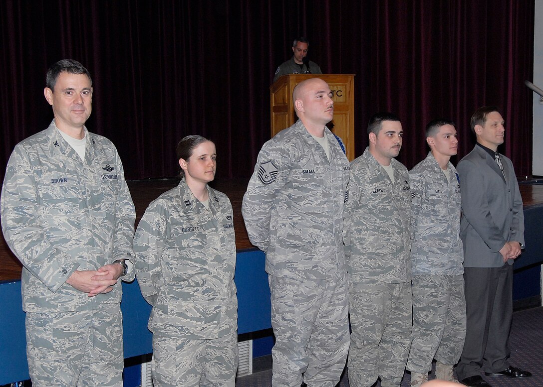 Col. Mike Brown (left), the Air Education and Training Command deputy inspector general, recognized and coined five individuals for their superior performance Feb. 10 during the 82nd Training Wing Outbrief. Pictured from left to right are Colonel Brown, Capt. Meghan Corbett, 366th Training Squadron; Master Sgt. Troy Small, 82nd TRW; Staff Sgt. Timothy Leeth, 361st TRS; Senior Airman Joe Mata, 365th TRS; and Michael Tiedeman, 82nd Comptroller Squadron. (U.S. Air Force photo/Harry Tonemah)