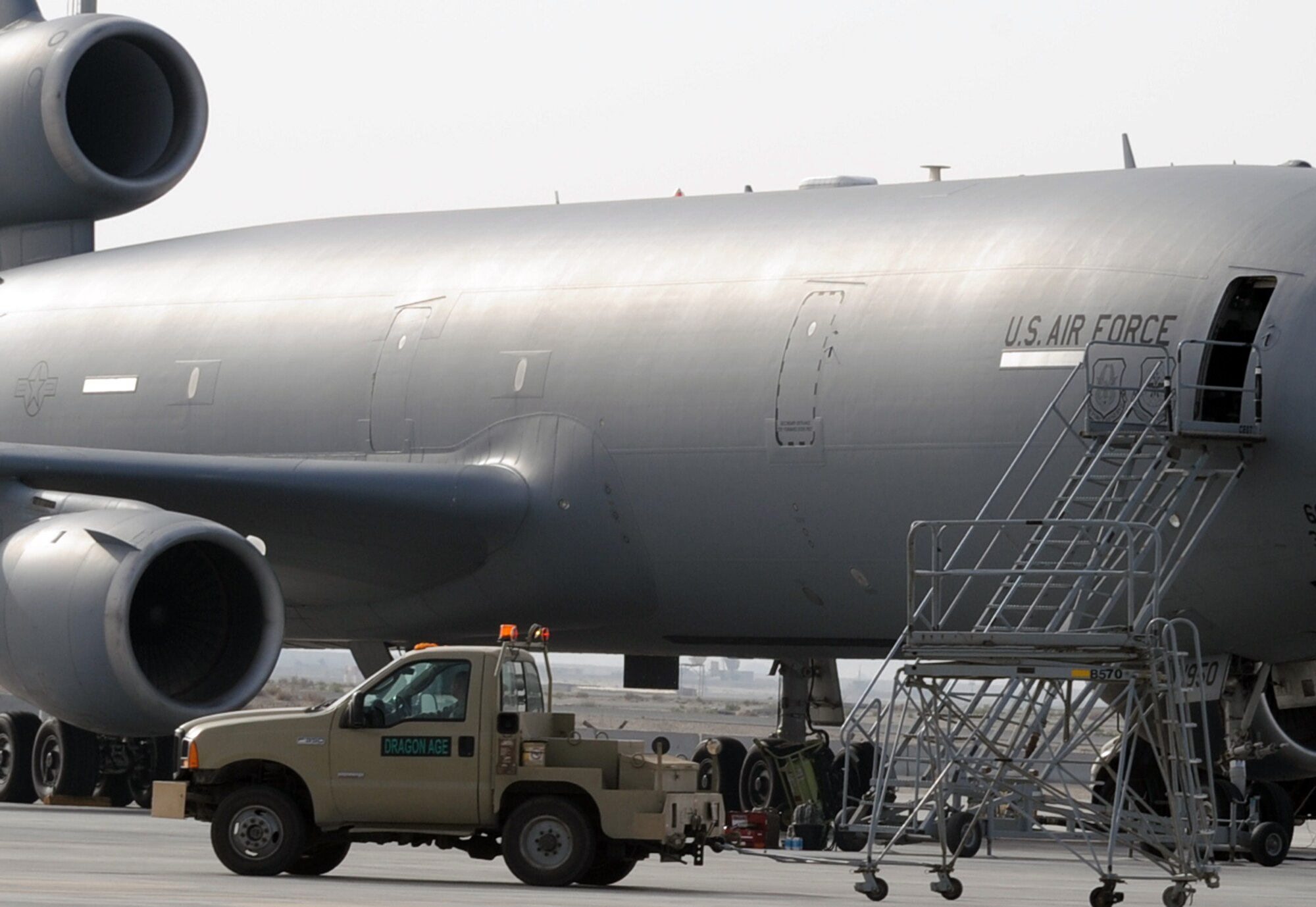 Maintenance Airmen use a vehicle to move air stairs to a KC-10 Extender during flightline operations at a non-disclosed base in Southwest Asia on Feb. 11, 2010.  The KC-10 Extender is a part of the 908th Expeditionary Air Refueling Squadron of the 380th Air Expeditionary Wing. KC-10s assigned to the 908th EARS fly combat air refueling missions in support of Operations Enduring Freedom, the Combined Joint Task Force-Horn of Africa and Operation Iraqi Freedom. The KC-10 is the Air Force's largest tanker and in 2009, aircraft assigned to the 908th EARS flew more than 4,700 combat missions offloading more than 422 million pounds of fuel to more than 31,400 aircraft.  (U.S. Air Force Photo/Master Sgt. Scott T. Sturkol/Released)