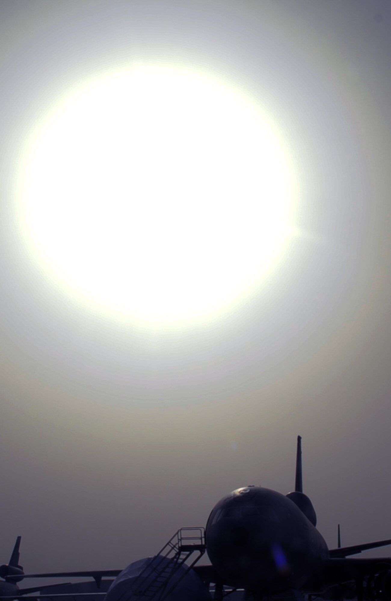 The sun silouettes a parked KC-10 Extender on the flightline at a non-disclosed base in Southwest Asia on Feb. 11, 2010.  The KC-10 Extenders are a part of the 908th Expeditionary Air Refueling Squadron of the 380th Air Expeditionary Wing. KC-10s assigned to the 908th EARS fly combat air refueling missions in support of Operations Enduring Freedom, the Combined Joint Task Force-Horn of Africa and Operation Iraqi Freedom. The KC-10 is the Air Force's largest tanker and in 2009, aircraft assigned to the 908th EARS flew more than 4,700 combat missions offloading more than 422 million pounds of fuel to more than 31,400 aircraft.  (U.S. Air Force Photo/Master Sgt. Scott T. Sturkol/Released)