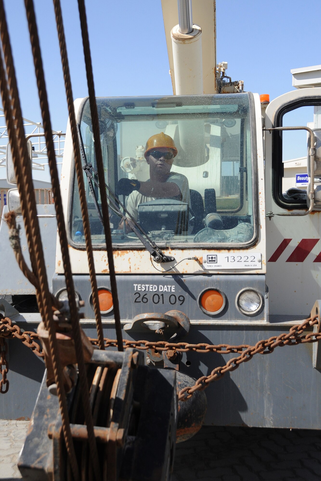 Staff Sgt. Marcus Ray, 380th Expeditionary Civil Engineer Squadron roads and grounds shop, operates a crane that is being used to install a new air conditioning unit at the dining facility at an undisclosed location in Southwest Asia on Feb. 10, 2010.  A new unit was installed to increase the cooling effeciancy for the building before summer temperatures rose. Sergeant Ray is deployed from the 21st CES at Peterson AFB, Colo. and hails from Lindale, Texas.(U.S. Air Force photo/Senior Airman Jenifer H. Calhoun/Released)
