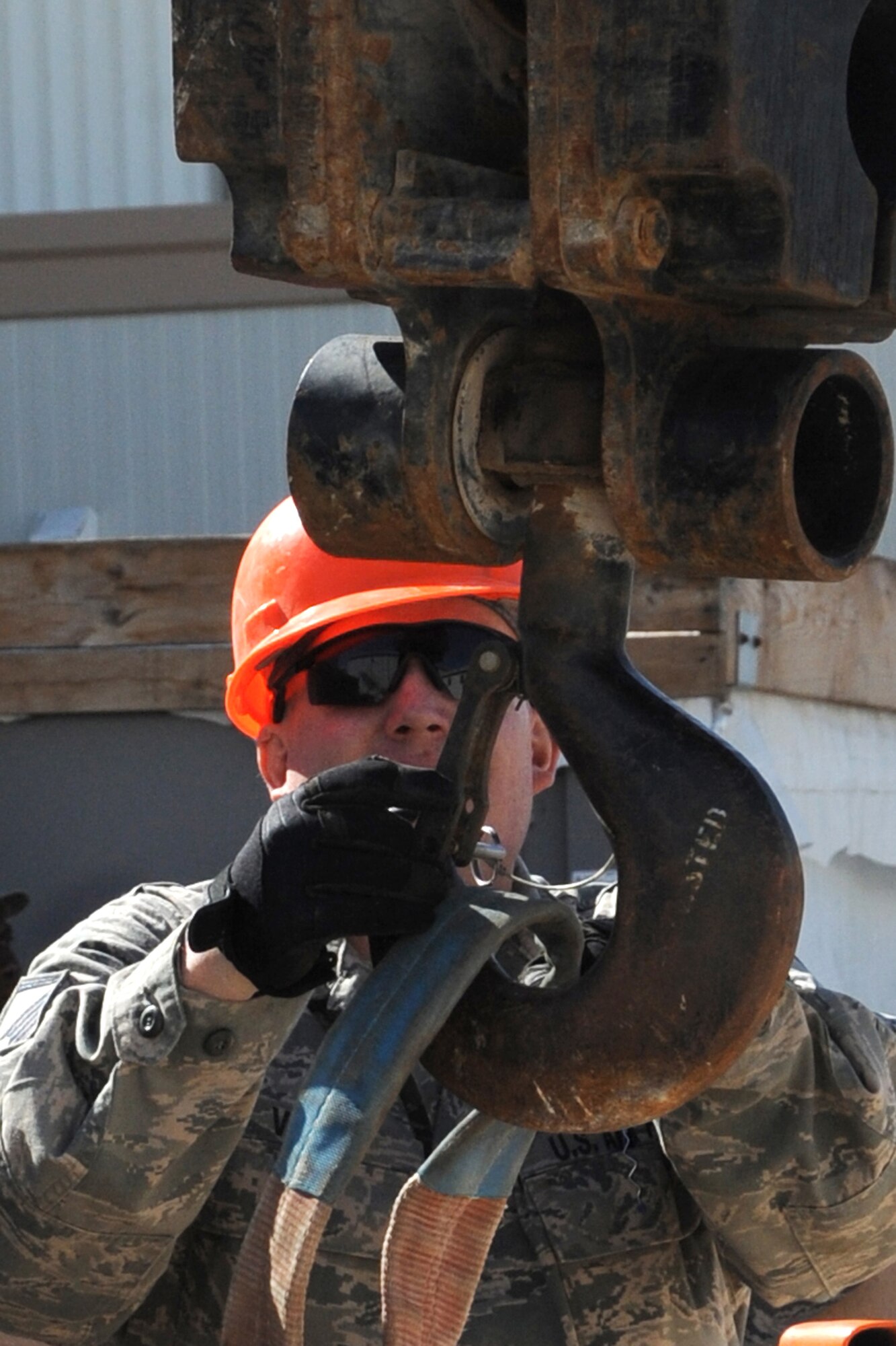 Master Sgt. Mark Voss, 380th Expeditionary Civil Engineer Squadron roads and grounds shop,hooks up slings to a crane to take an air conditioning unit from the dining facility at an undisclosed location in Southwest Asia on Feb. 10, 2010.  A new unit was installed to increase the cooling efficiency for the building before summer temperatures rose.Sergeant Voss is dpeloyed from the 319th CES at Grand Forks AFB, N.D. and hales from Huron, S.D.(U.S. Air Force photo/Senior Airman Jenifer H. Calhoun/Released)
