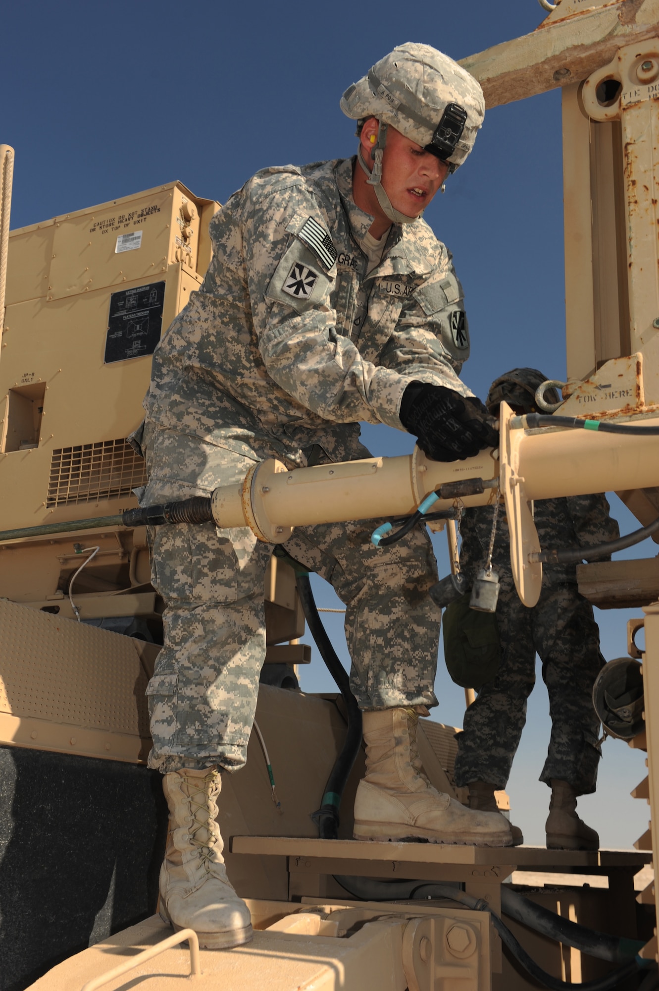 Army Pfc. Michael Grace, Bravo Battery 1-43 ADA Patriot Launch Station operator/maintainer, connects an antenna cable during a missile reload certification event at a non-disclosed Southwest Asia location, Feb. 8, 2010. (U.S. Air Force photo by Tech. Sgt. Michelle Larche)[RELEASED]