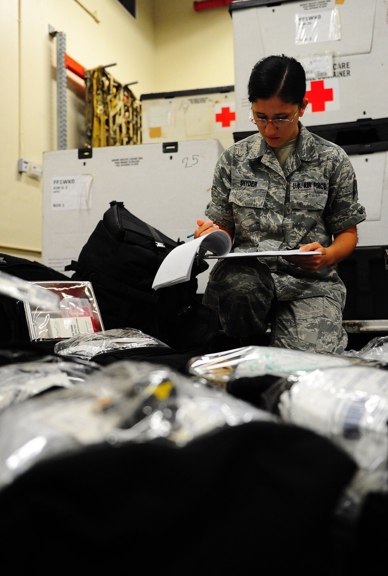Airman 1st Class Jeanie Snyder, a 36th Medical Support Squadron Medical Logistics flight member, inventories and inspects a medical equipment bag. Airman Snyder was selected as top performer by her supervisors for her hard work to ensure the hospital didn't suffer mission degradation when a large part of her flight was called out to assist during a natural disaster in Indonesia. Airman Snyder has also been recognized as Airman of the Quarter twice and Airman of the Year for her squadron. (U.S. Air Force photo by Tech. Sgt. Mike Andriacco)