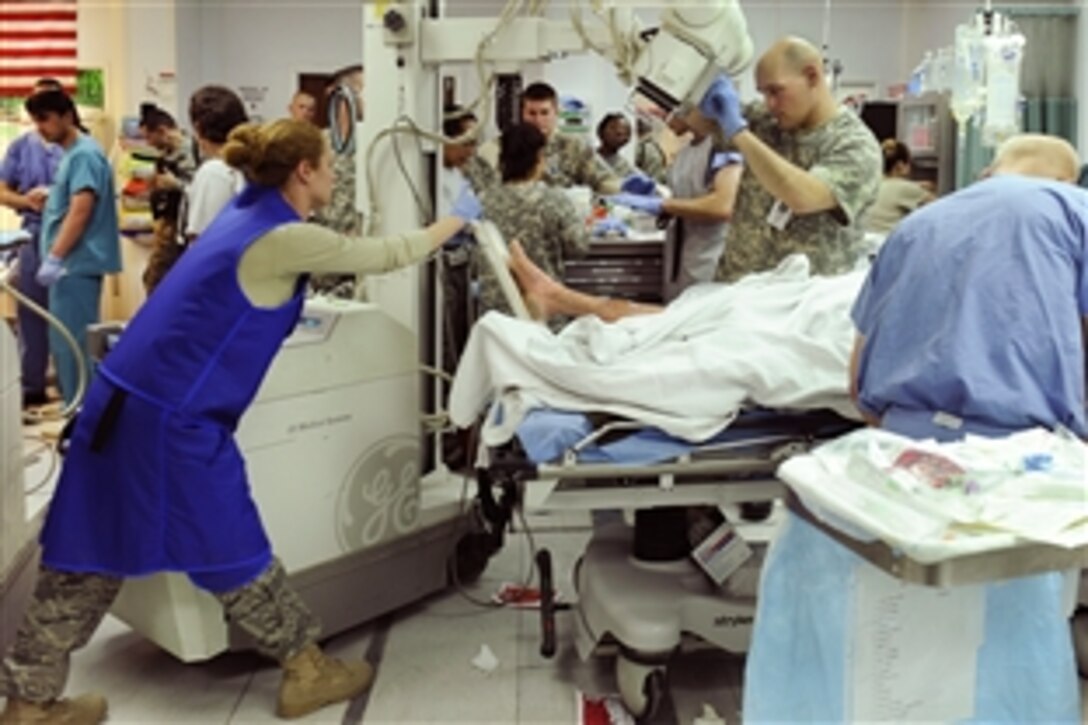 U.S. airmen from the 455th Expeditionary Medical Group work in the emergency room to save  avalanche victims who were medically evacuated to Craig Joint Theater Hospital on Bagram Airfield, Afghanistan, Feb. 9, 2010. Dozens of Afghans were transported to Bagram Airfield after avalanches struck a mountain pass in Parwan province.