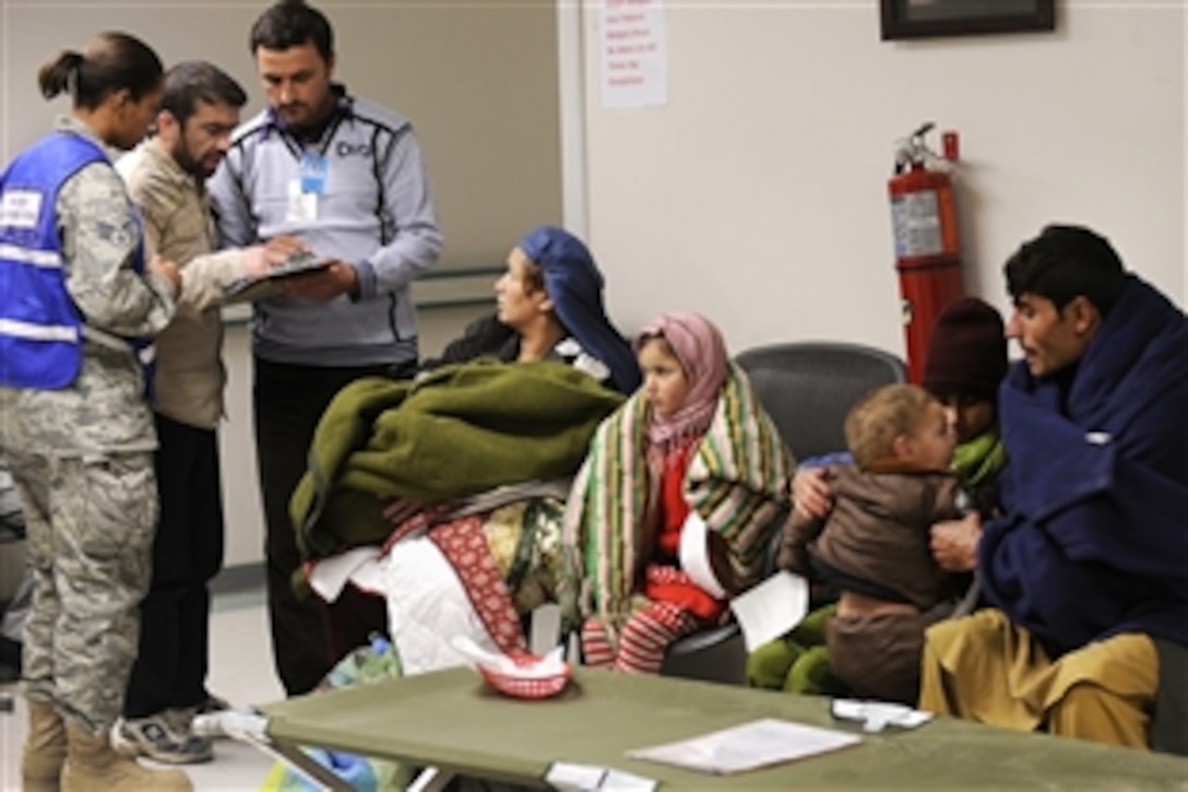 U.S. Air Force Senior Airman Katrevious Swift and Afghan doctors Shekib Hassanzada, left, and Abdul Hashim discuss care for avalanche survivors at Craig Joint Theater Hospital on Bagram Airfield, Afghanistan, Feb. 9, 2010. Dozens of Afghans were taken to Bagram Airfield after avalanches struck a mountain pass in Parwan province. Swift is assigned to the 455th Expeditionary Medical Group.