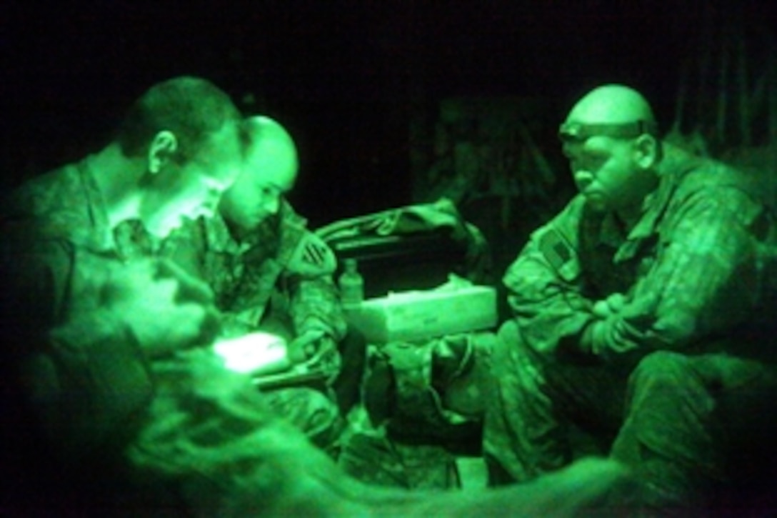 As seen through a night-vision device, U.S. Army soldiers, members of a Chinook helicopter crew, receive a flight briefing on Falcon Base, Afghanistan, Feb. 10, 2010. The crew is assigned to the 3rd Battaltion, 17th Cavalry Regiment, 3rd Combat Aviation Brigade, which provides tactical support and transportation.