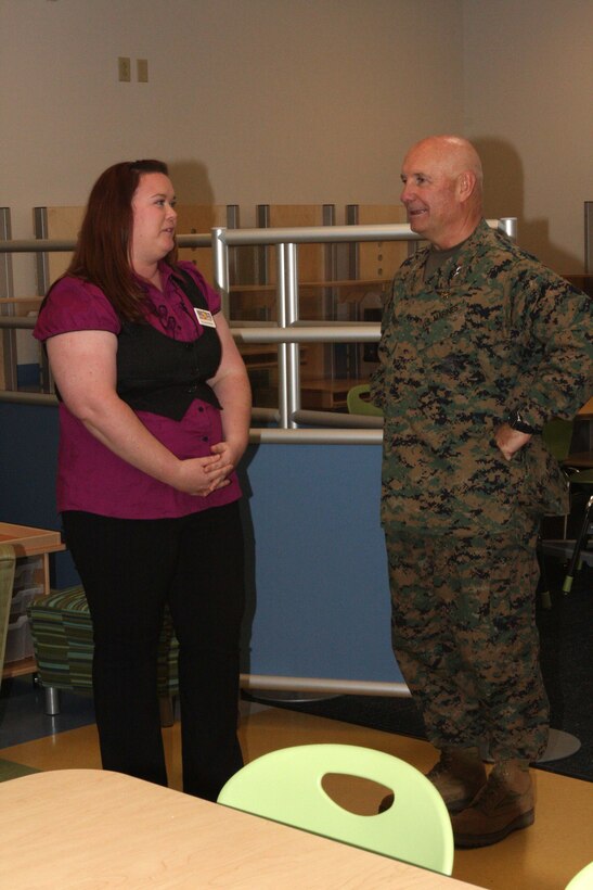 Major General Thomas L. Conant learns about the features of the 8 to 12-year-old classroom from Ms. Chelsea, a Miramar Child Youth and Teen Center teacher. Major General Conant toured the classrooms after the center's ribbon cutting ceremony here on Feb. 11, 2009.