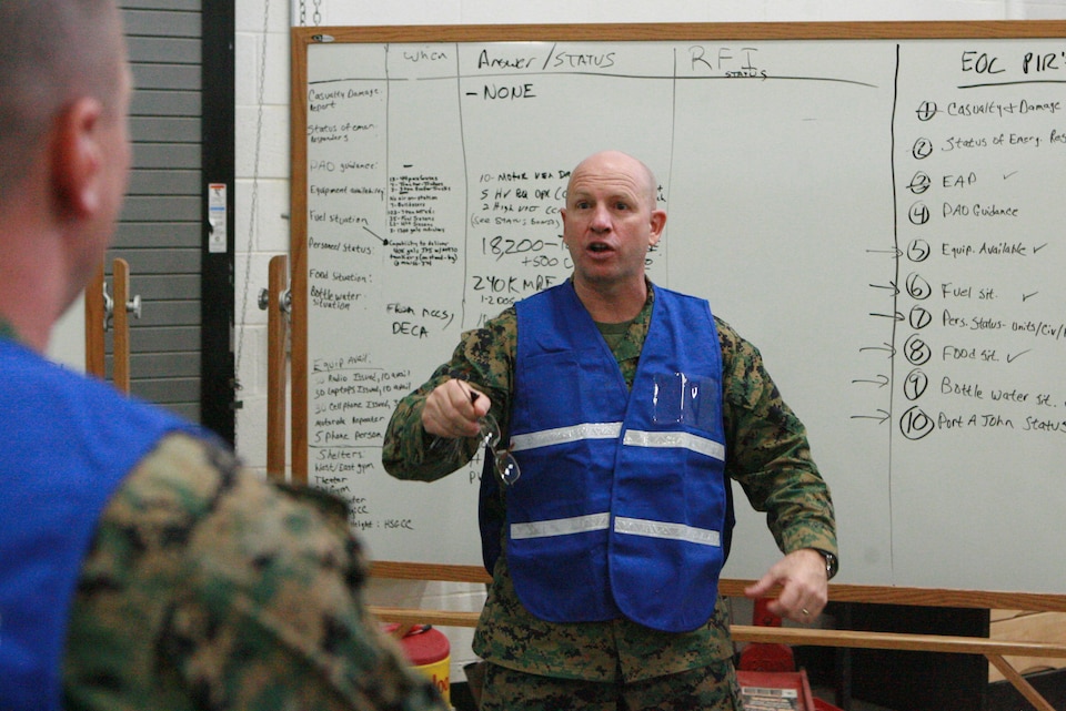 Col. Wes. S. Weston, the logistics section chief for the emergency operations center simulation, explains the emergency operations data collected to the logistics section during the debrief Feb 11.