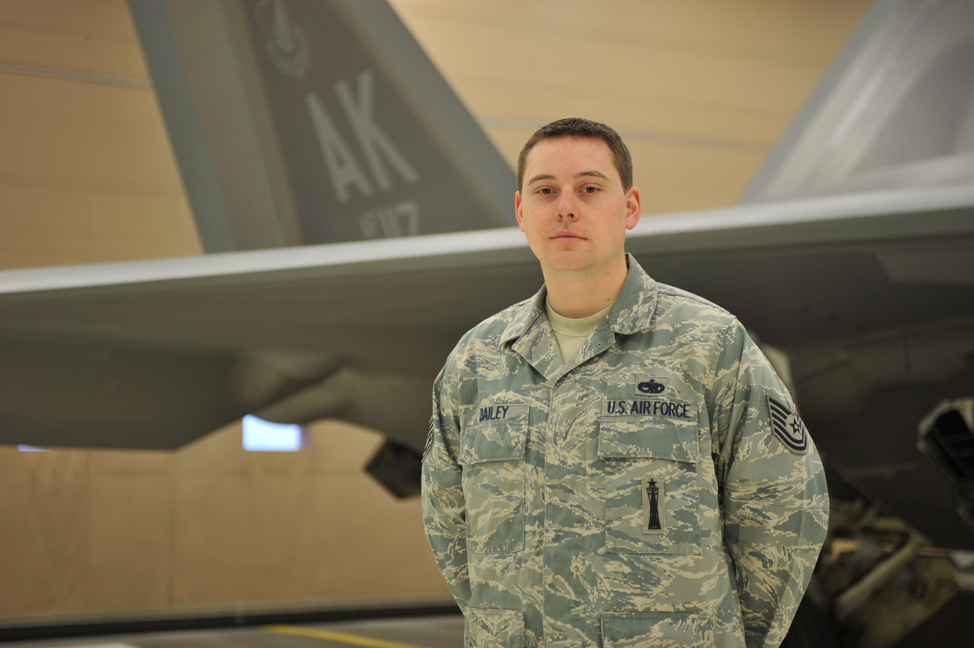 ELMENDORF AIR FORCE BASE, Alaska -- Tech. Sgt. Bishop Bailey, 477th Aircraft Maintenance Squadron, stands in front of an F-22 Raptor Feb. 12. Bailey was named the Air Force Reserve Command's 2009 Lieutenant General Leo Marquez Award recipient technician supervisor. This award is presented to maintainers who have demonstrated the highest degree of sustained job performance, job knowledge, job efficiency and results in the categories of aircraft, munitions and missile, and communications-electronics maintenance. (Air Force photo by Senior Airman David Carbajal)