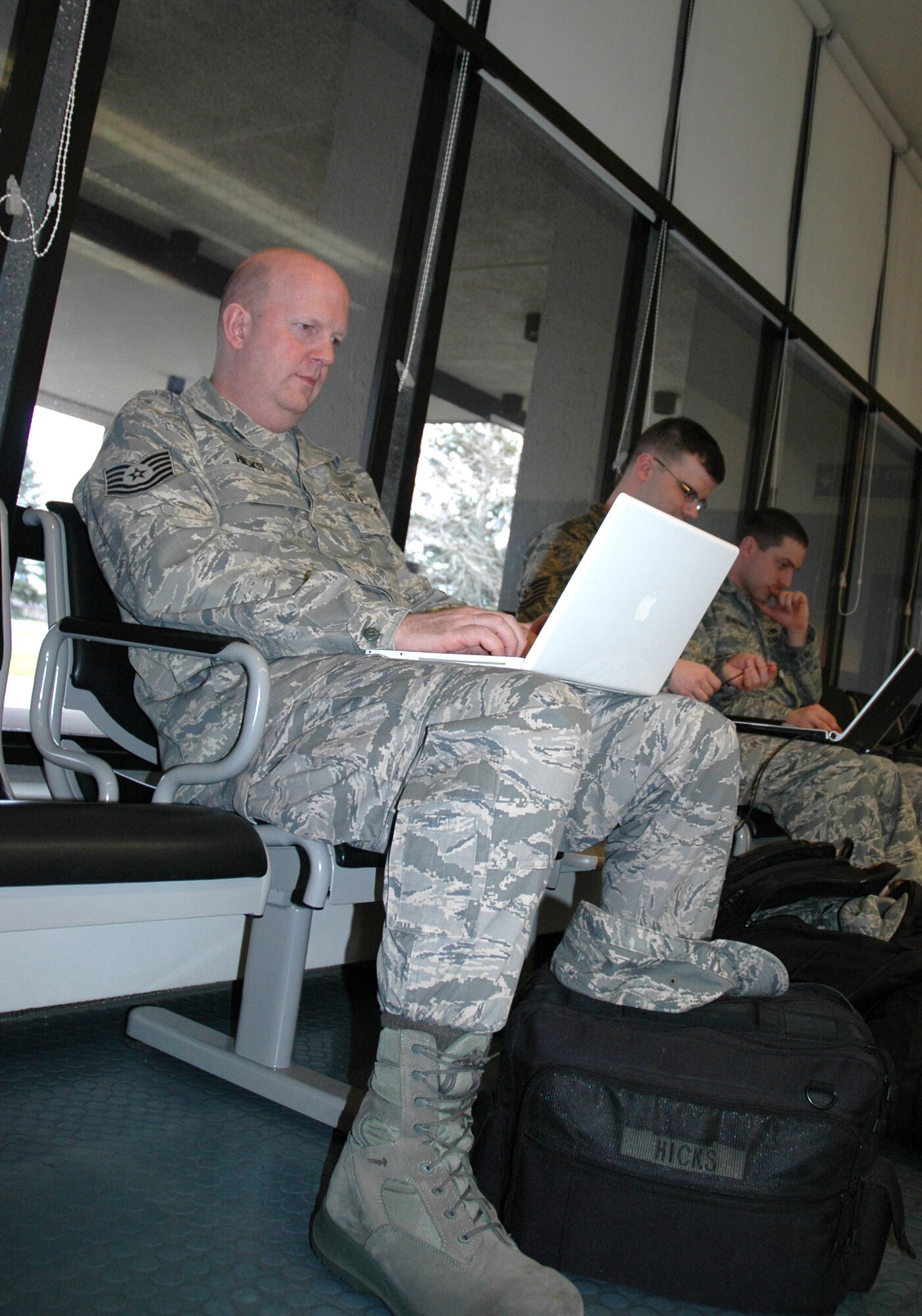 JOINT BASE LEWIS-MCCHORD, Wash., - Tech. Sgt. William Hicks spends some down time on his laptop as he waits to depart for Haiti.  Sergeant Hicks and Tech. Sgt. Michael Hurt, 446th Maintenance Squadron, are deploying in support of Operation Unified Response.  Sergeant Hicks is a traditional Reservist who hails from Kansas and works for Southwest Airlines in his civilian employment. (U.S. Air Force photo/Sandra Pishner)