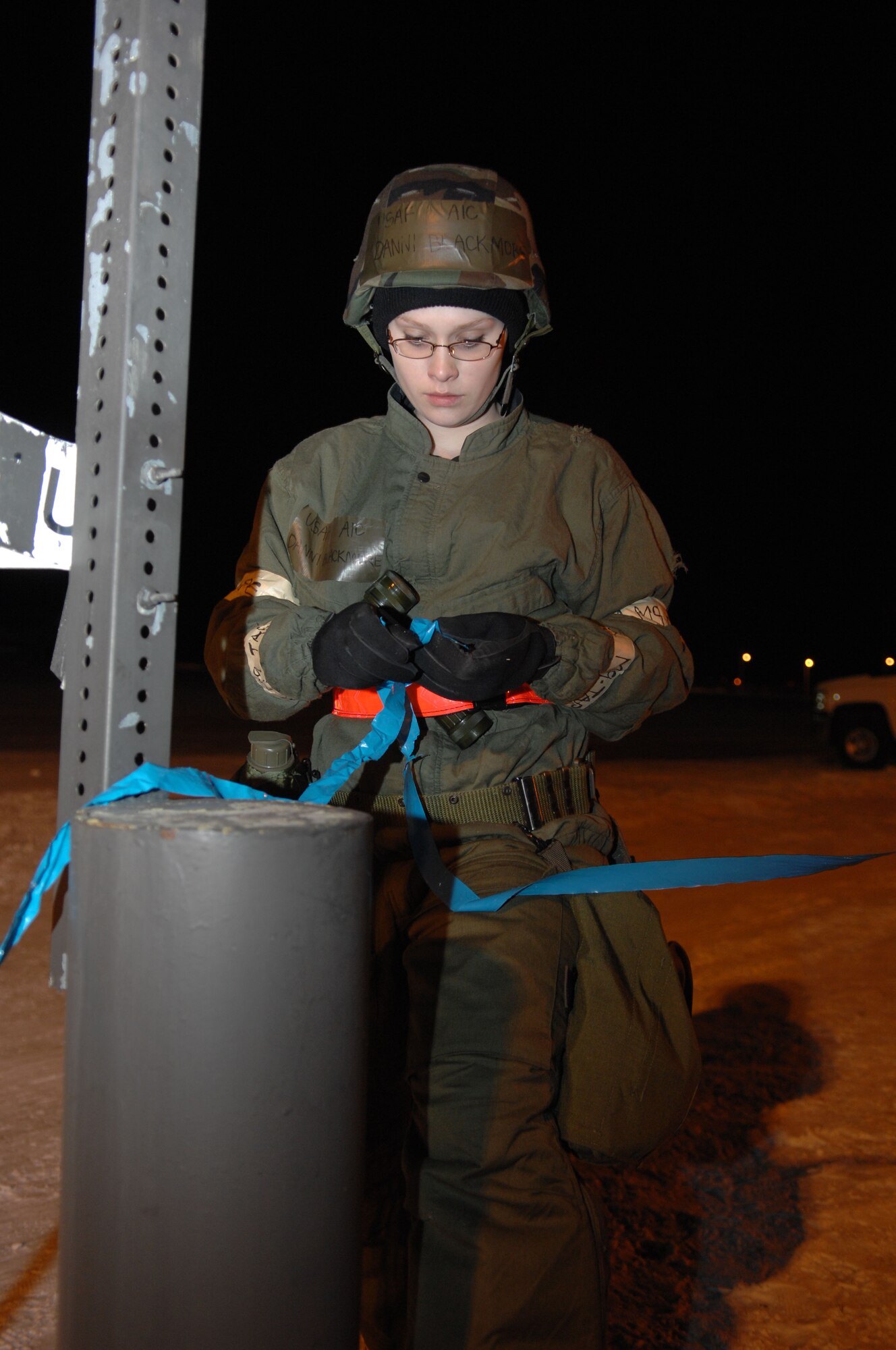 MINOT AIR FORCE BASE, N.D. – Airman 1st Class Dannie Blackmore, 5th Operations Support Squadron aircrew flight equipment apprentice, checks the M-9 chemical tape while on a post-attack reconnaissance sweep during the Prairie Knight 10-1 exercise here Feb. 11. Prairie Knight is a semi-annual exercise geared to prepare the 5th Bomb Wing Warbirds for a conventional warfare environment and its August 2010 conventional operational readiness inspection. (U.S. Air Force photo by Senior Airman Michael J. Veloz)
