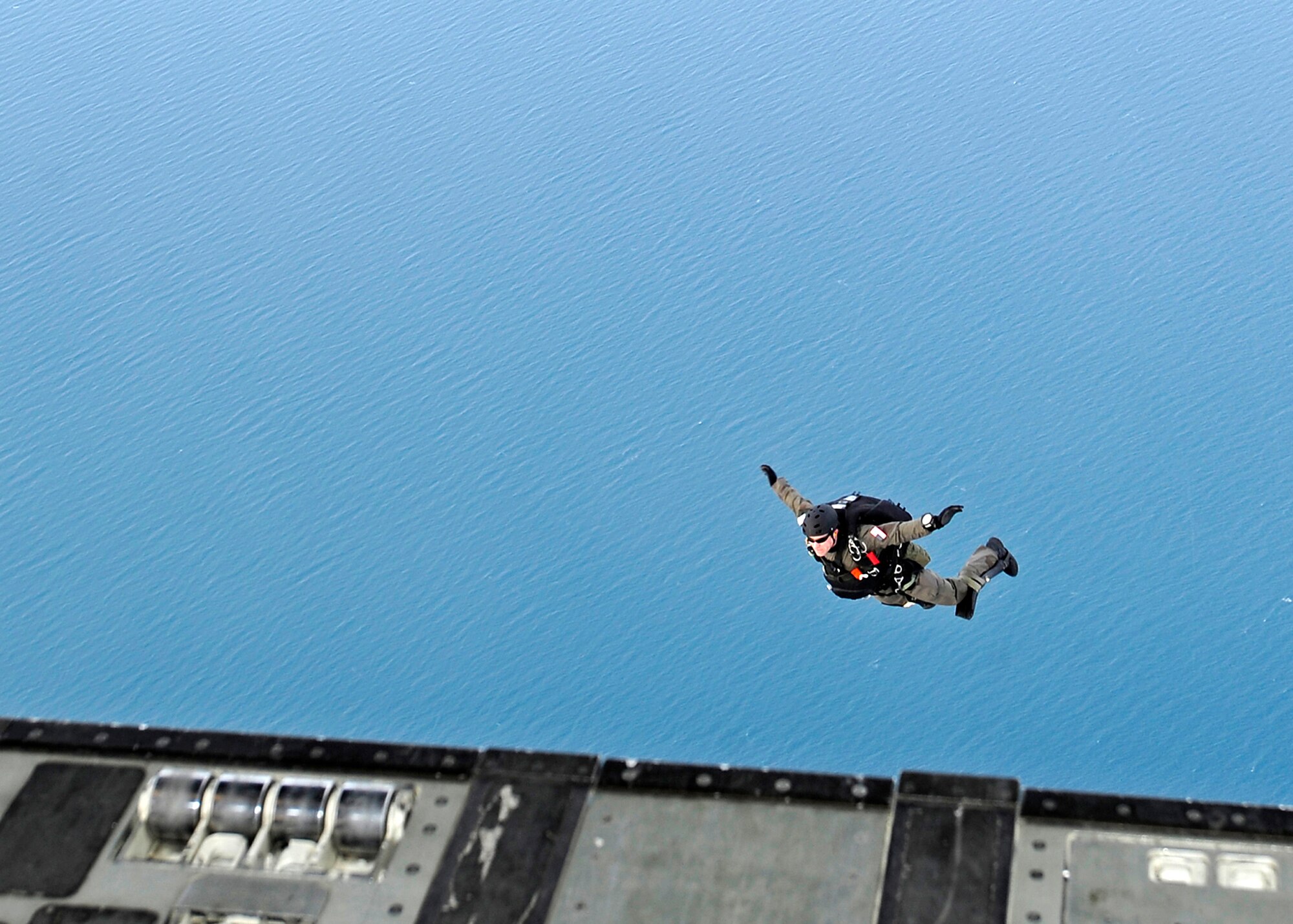 ELMENDORF AIR FORCE BASE, Alaska -- A pararescueman from the 212th Rescue Squadron, jumps from a C-17 Globemaster III over Katchemak bay, Alaska Feb. 10. The pararescueman was participating in an exercise that involved Pacific Air Force and Air Mobility Command C-17?s exploring capabilities in large formations and improving tactical awareness among aircrews. (Air Force photo by Senior Airman Matt Coleman-Foster)