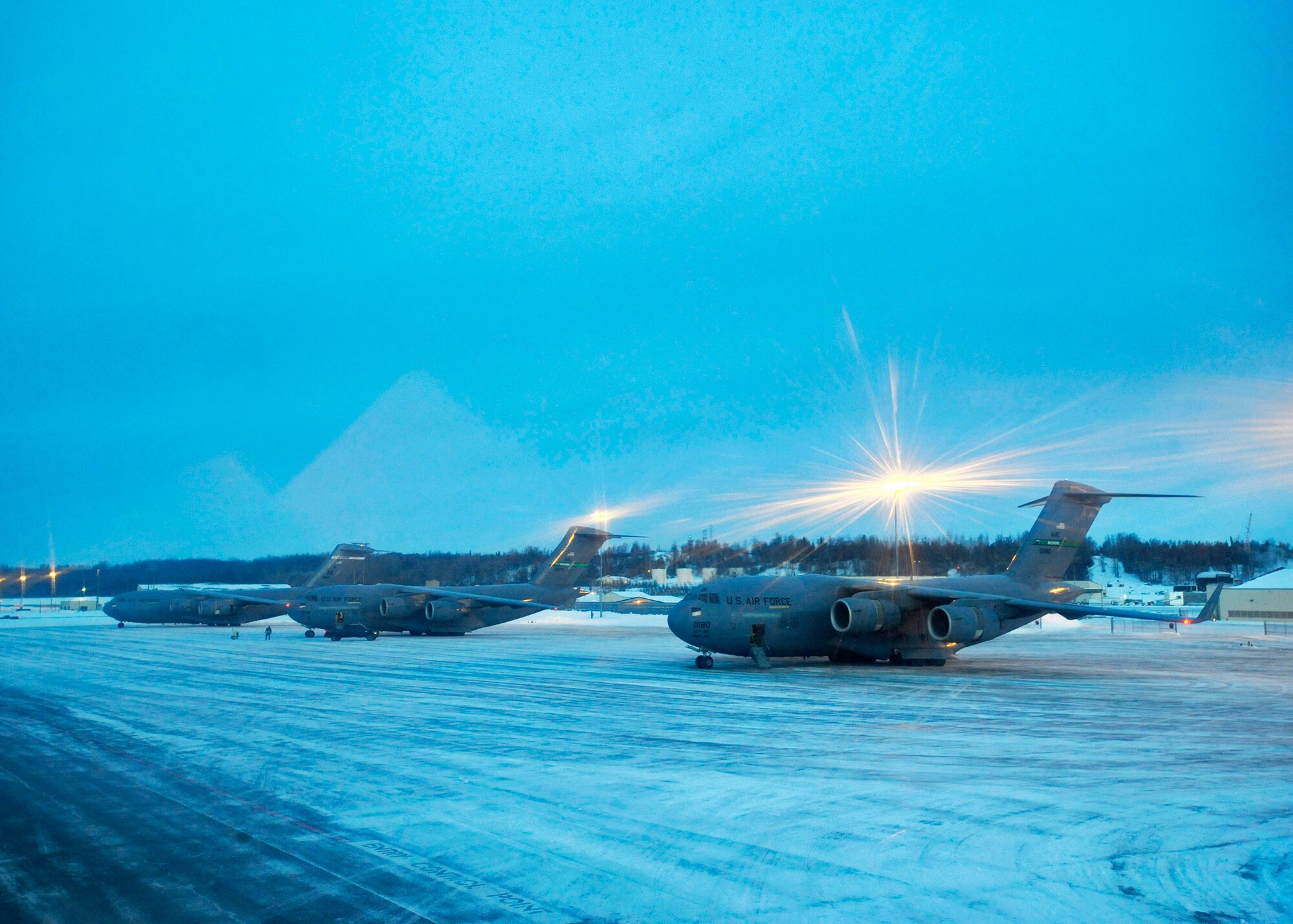 ELMENDORF AIR FORCE BASE, Alaska -- C-17 Globemaster IIIs assigned to Pacific Air Forces and Air Mobility Command sit on the ramp here waiting to take off Feb. 10. The aircraft were participating in an exercise that involved PACAF and AMC C-17s exploring capabilities in large formations and improving tactical awareness among aircrews. (Air Force photo by Senior Airman Matt Coleman-Foster)