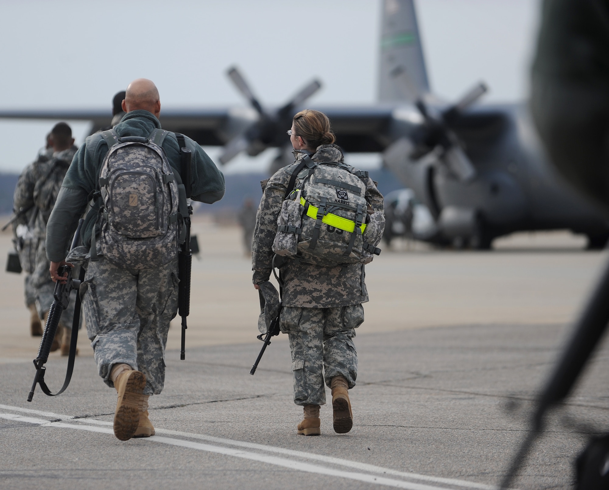 LANGLEY AIR FORCE BASE, Va. – Soldiers representing several different companies from Fort Lee, Va., board a C-130 Hercules Feb. 12. The C-130 is transporting 47 soldiers, as well as supplies, to Haiti in support of Operation Unified Response, a joint relief effort bringing aid to the devastated country. (U.S. Air Force photo/Airman Rebecca Montez)