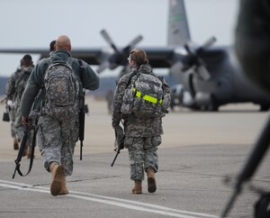 LANGLEY AIR FORCE BASE, Va. – Soldiers representing several different companies from Fort Lee, Va., board a C-130 Hercules Feb. 12. The C-130 is transporting 47 soldiers, as well as supplies, to Haiti in support of Operation Unified Response, a joint relief effort bringing aid to the devastated country. (U.S. Air Force photo/Airman Rebecca Montez)