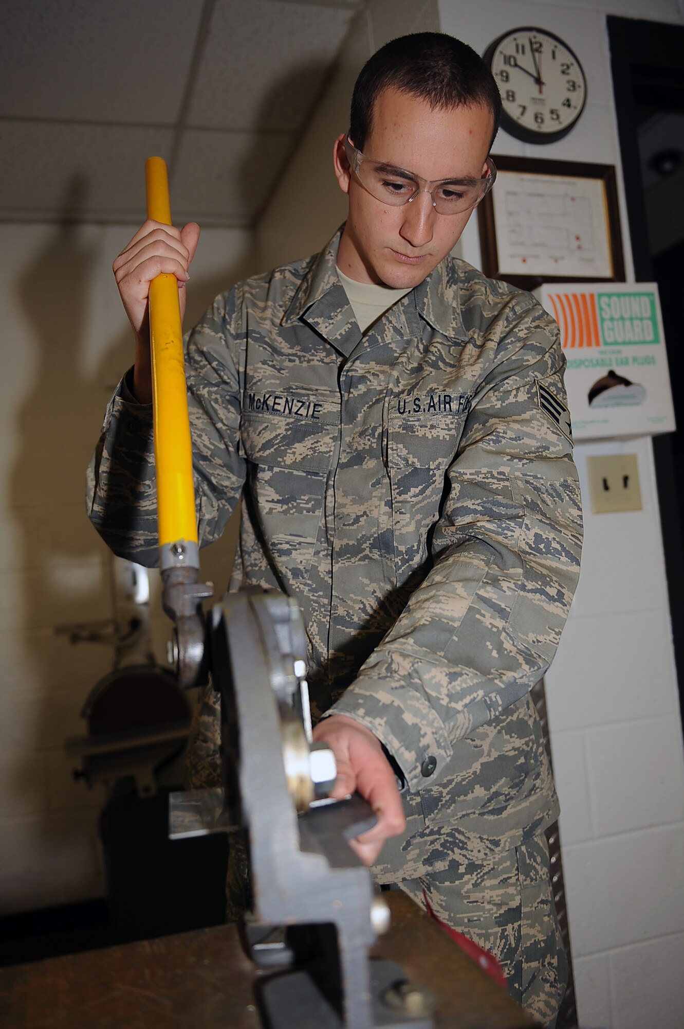 Senior Airman John McKenzie, 4th Equipment Maintenance Squadron aircraft structural maintenance journeyman, cuts metal patches for an aircraft replacement part at Seymour Johnson Air Force Base, N.C., Feb. 12, 2010. To cut the patches Airman McKenzie uses throat-less shears, a cutting tool that makes straight and complex cuts in sheet metal. McKenzie hails from Roseville, Calif. (U.S. Air Force photo/Senior Airman Ciara Wymbs) 