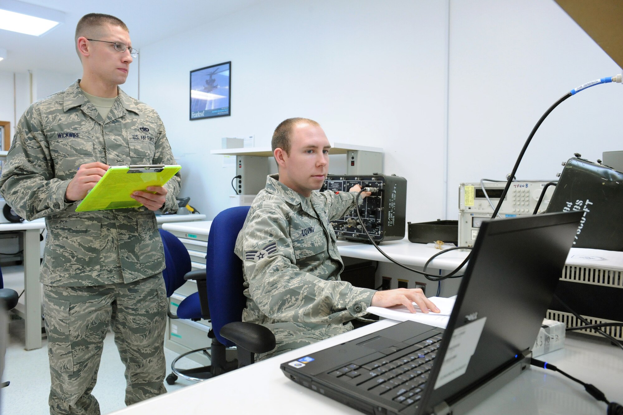 Staff Sgt. Russell Wickwire, 4th Component Maintenance Squadron quality program evaluator, evaluates Senior Airman John Loving, 4th CMS test, measurement and diagnostic equipment technician, on calibrating a Tactical Air Navigation test on Seymour Johnson Air Force Base, N.C., Feb. 11, 2010. The TACAN test allows an aircrew to find exactly where they are at with respect to the ground station or other aircraft. TACAN supports all C-130 aircraft at Pope, Air Force Base, N.C. Wickwire hails from Norton, Ohio and Loving hails from San Diego. (U.S. Air Force photo/Senior Airman Whitney Lambert)