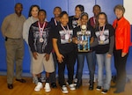 Students of Woodlake Hills Middle School show off their trophy and
individual medallions after winning their division in the annual African
American Heritage Knowledge Bowl at Randolph High School here. Competition judges, Maj. Gen. K.C. McClain, commander of the Air
Force Personnel Center, and Maj. William Collins, chairman of the African
American Heritage Committee, share the spotlight. This winning team
consisted of Krishae Wallace-Ball, Tiara Egglestin, Stephanie Santana,
Joshua Tyler, Cedric Williams, Ondrea Spearman and Willie Davis. The coach
was Teonna Rector. (Courtesy photo)
