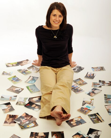 MOODY AIR FORCE BASE, Ga. -- 2nd Lt. Chelsey Garrison, 23rd Wing Public Affairs deputy chief, poses surrounded by pictures of her and her husband during a photo session here Feb. 11. Her husband is currently stationed more than 17 hours away and has been there for more than half of their marriage. “Being in a ‘mil-to-mil’ marriage is not always easy and at times it can be very difficult, but we understand each other’s situation and we work to make our relationship successful,” said Lieutenant Garrison. (U.S. Air Force Photo by Airman 1st Class Benjamin Wiseman)
