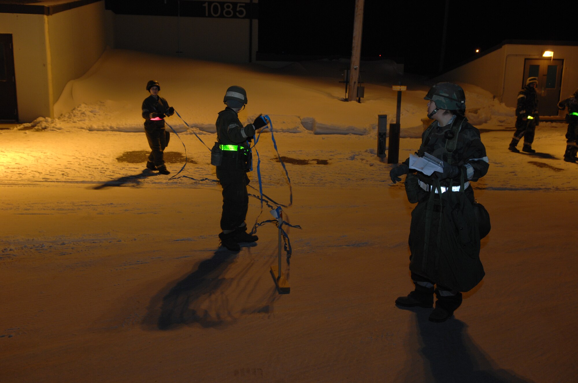MINOT AIR FORCE BASE, N.D. -- Airmen from the 5th Bomb Wing begin marking an area around an unexploded ordinance during the Prairie Knight 10-1 exercise Feb. 11, here.  Prairie Knight is a semi-annual exercise geared to prepare the 5th Bomb Wing Warbirds for a conventional warfare environment and its August 2010 conventional operational readiness inspection. 