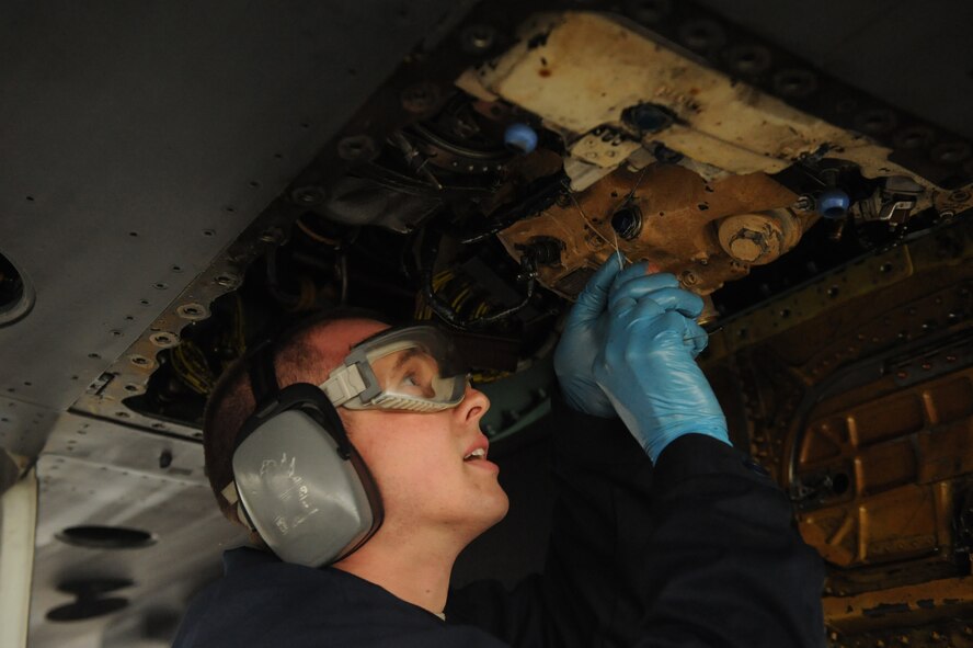SEYMOUR JOHNSON AIR FORCE BASE, N.C. -- Staff Sgt. Nathan Thompson, 336th Aircraft Maintenance Unit electric environment specialist, safety wires an integrated drive-gear filter on an F-15E Strike Eagle at Seymour Johnson Air Force Base, N.C., Feb. 9, 2010. The IDG filter is the main generator on the jet and it is mandatory to safety wire the IDG filter after every change. Sergeant Thompson is from Grayling, Mich. (U.S. Air Force photo/Senior Airman Whitney Lambert)