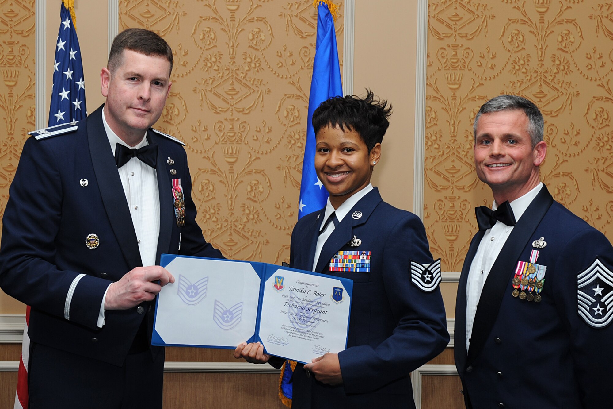 LANGLEY AIR FORCE BASE, Va. -- Col. Donald E. Kirkland, 633d Air Base Wing commander, and Chief Master Sgt. Charles Anderson, 633d Air Base Wing command chief, promote Staff Sgt. Tamika Boler during the Airman Leadership School graduation ceremony Feb. 11.  Sergeant Boler was promoted to technical sergeant as part of the Stripes for Exceptional Performers Program.  (U.S. Air Force photo/Senior Airman Zachary Wolf)