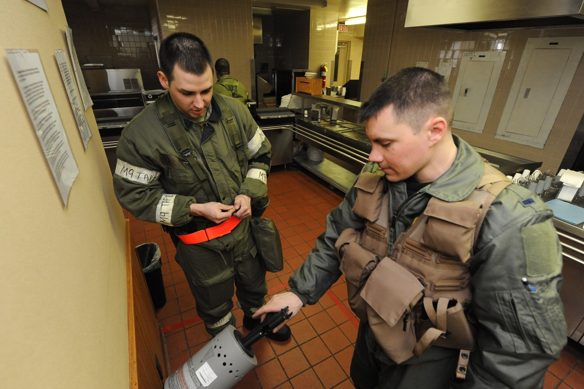 MINOT AIR FORCE BASE, N.D. -- Airman 1st Class Christopher McCain, 5th Operations Support Squadron aircrew flight equipment apprentice, looks on as 1st Lt. Stephen Bailey, 23rd Bomb Squadron aircrew member clears his weapon during Prairie Knight 10-1 here Feb. 11. Prairie Knight is a semi-annual exercise geared to prepare the 5th Bomb Wing Warbirds for a conventional warfare environment and its August 2010 conventional operational readiness inspection. (U.S. Air Force photo by Senior Airman Jesse Lopez)