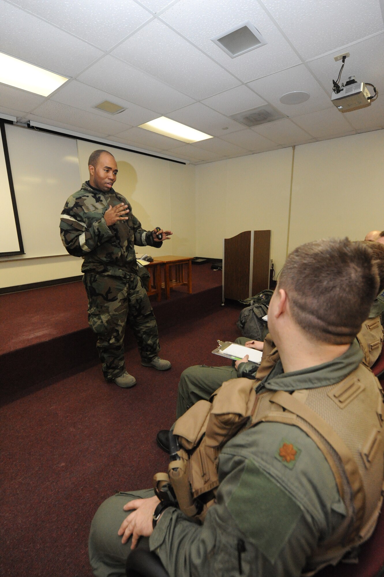 MINOT AIR FORCE BASE, N.D. -- Capt. Rolland Coleman, 5th Operations Support Squadron mission plan executive, delivers an intelligence brief to 69th Bomb Squadron flight crew members during Prairie Knight 10-1 here Feb. 11. Prairie Knight is a semi-annual exercise geared to prepare the 5th Bomb Wing Warbirds for a conventional warfare environment and its August 2010 conventional operational readiness inspection. (U.S. Air Force photo by Senior Airman Jesse Lopez)