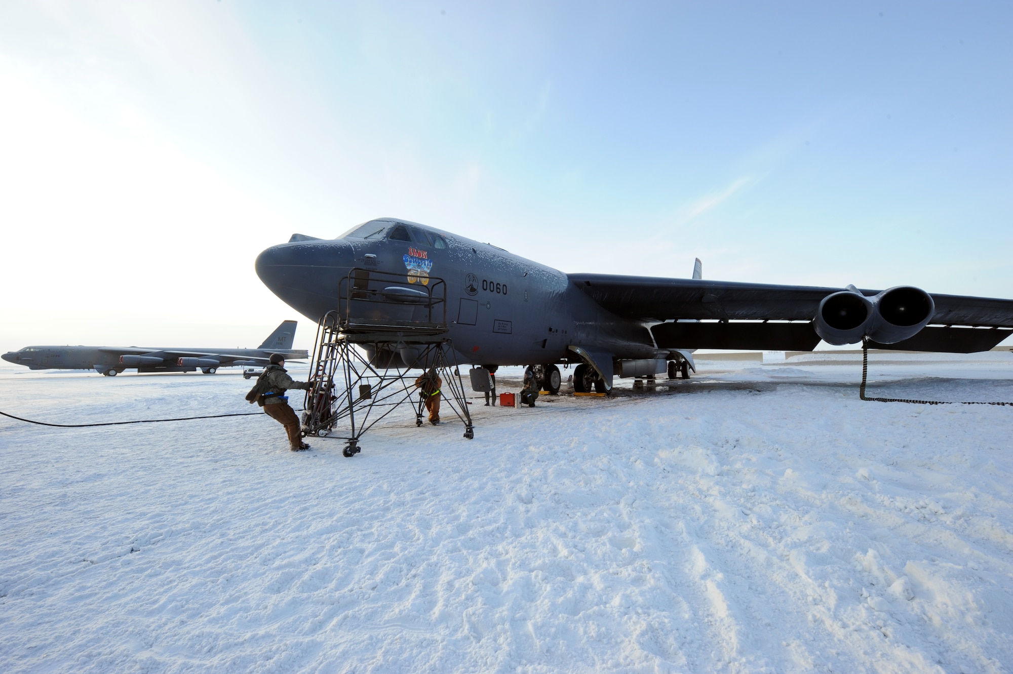 MINOT AIR FORCE BASE, N.D. -- Senior Airman William Poulos and Airman 1st Class Gregory Moran, 5th Aircraft Maintenance Squadron crew chiefs, prepare to deice the windows of a B-52 Stratofortress during Prairie Knight 10-1 here Feb. 11. Prairie Knight is a semi-annual exercise geared to prepare the 5th Bomb Wing Warbirds for a conventional warfare environment and its August 2010 conventional operational readiness inspection. (U.S. Air Force photo by Senior Airman Jesse Lopez)