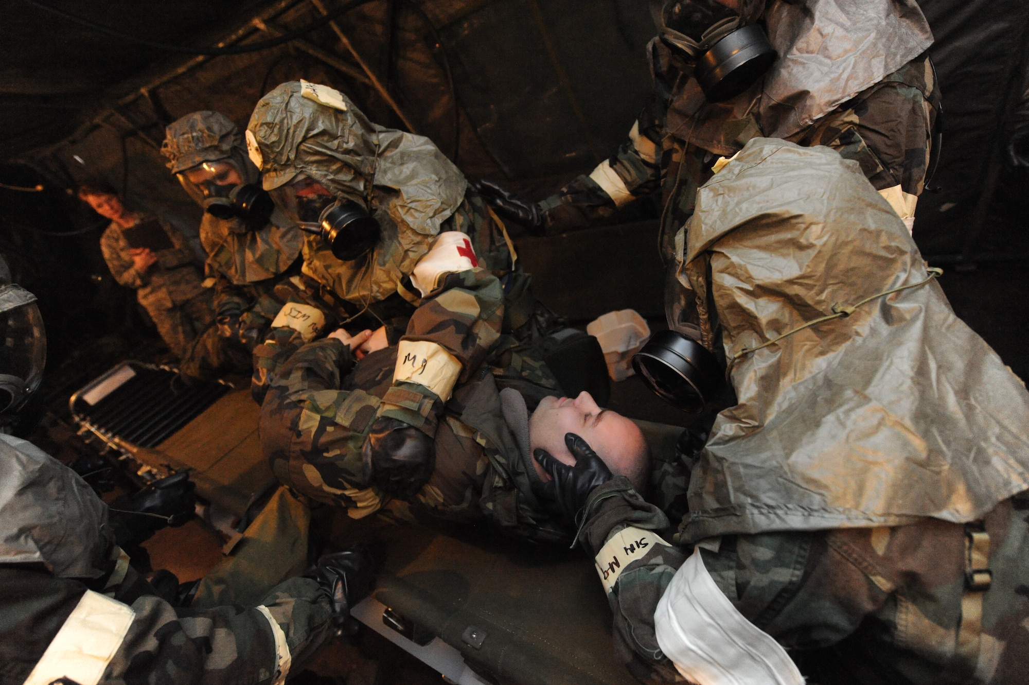 MINOT AIR FORCE BASE, N.D. -- The 5th Medical Operations Squadron decontamination team  decontaminates Staff Sgt. Tyler Hughes, 5th Aircraft Maintenance Squadron aerospace propulsion craftsman, a moulage victim suffering contamination as part of Prairie Knight 10-1 here Feb. 9. Prairie Knight 10-1 is an exercise geared to prepare the 5th Bomb Wing Warbirds for a conventional warfare environment. (U.S. Air Force photo by Senior Airman Jesse Lopez)
