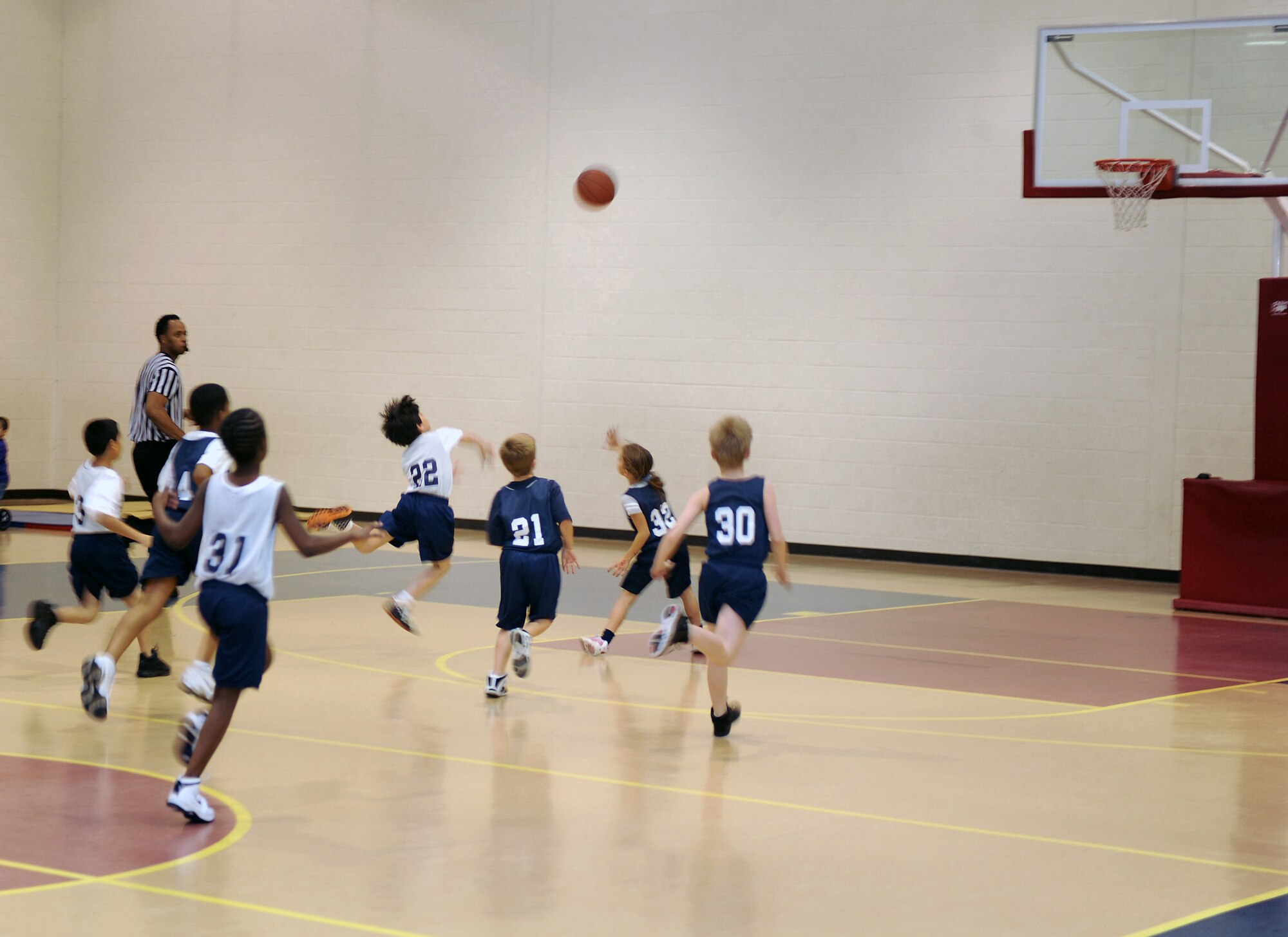 Kevin Perez (#22), Wolves guard, launches a three-point shot during a basketball game against the Sharks at the Seymour Johnson Air Force Base Youth Center Feb. 5, 2010.  The Wolves and Sharks are part of the Seymour Johnson youth basketball program and compete against teams from the Boys and Girls Club, YMCA, Wayne Country Day School, Woodman of the World, Eureka, Northeast and Northwest. Kevin is the son of Staff Sgt. Rocky Perez, 4th Equipment Maintenance Squadron sheet metal support section noncommissioned officer in charge. (U.S. Air Force photo/Tech. Sgt. Lesley Waters)