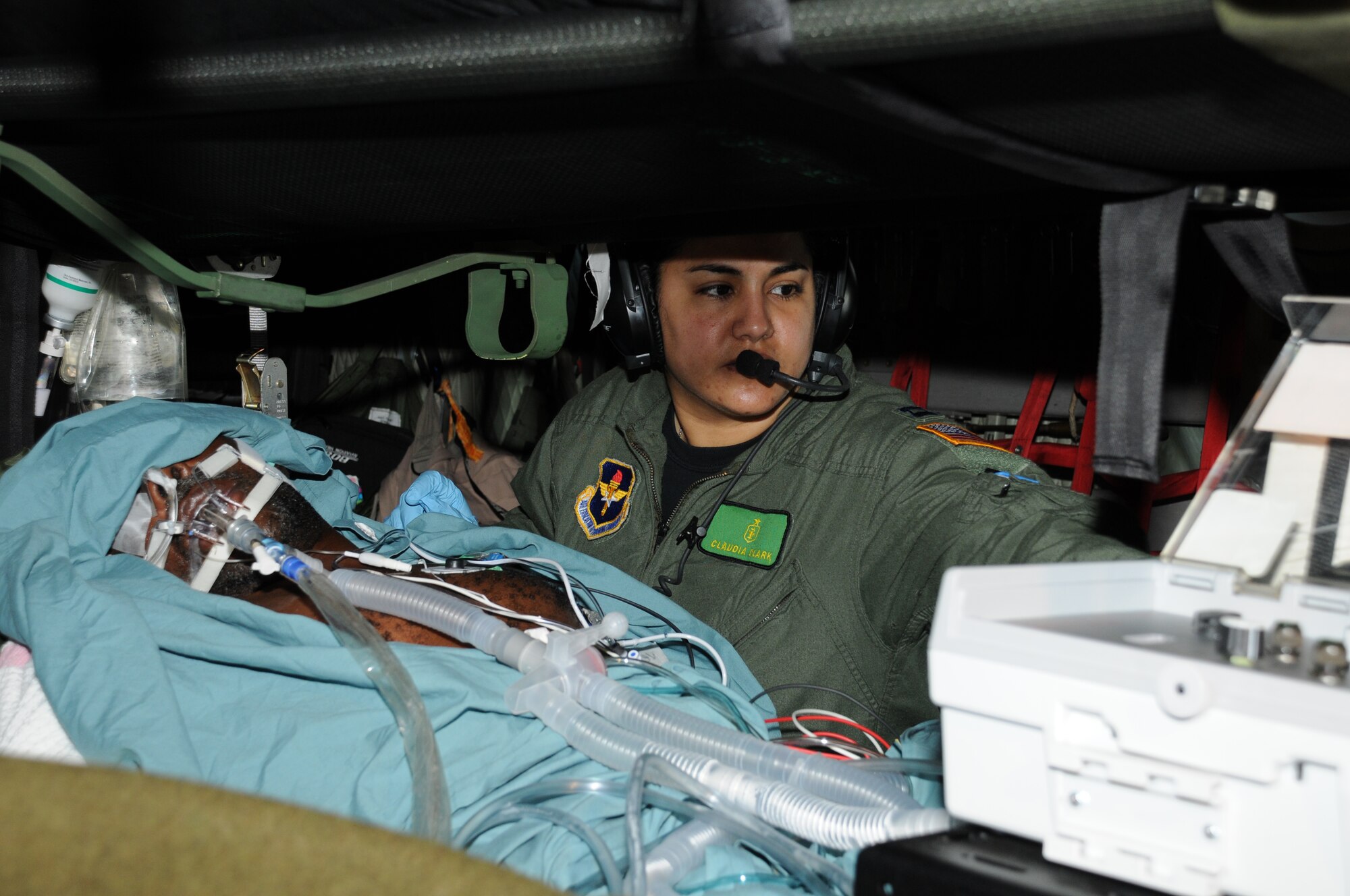 Capt. Claudia Clark, a critical care flight nurse with the 81st Medical Group from Kessler Air Force Base in Miss., cares for a male Haitian patient on board a C-130 Hercules on Feb. 2, 2010.  The patient is in the advanced stages of tetanus. (U.S. Air Force photo/Tech. Sgt. Denise Hauser)