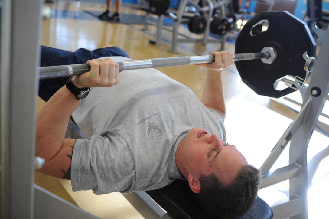 ELLSWORTH AIR FORCE BASE S.D.-- Airman 1st Class John Hall, Air Force Financial Services Center finance technician, bench presses weights at the Bellamy Fitness Center, Feb. 11. Airman Hall, a native of Slidell, La., is developing a fitness lifestyle by exercising at least three times a week. (U.S. Air Force photo/Airman 1st Class Corey Hook)