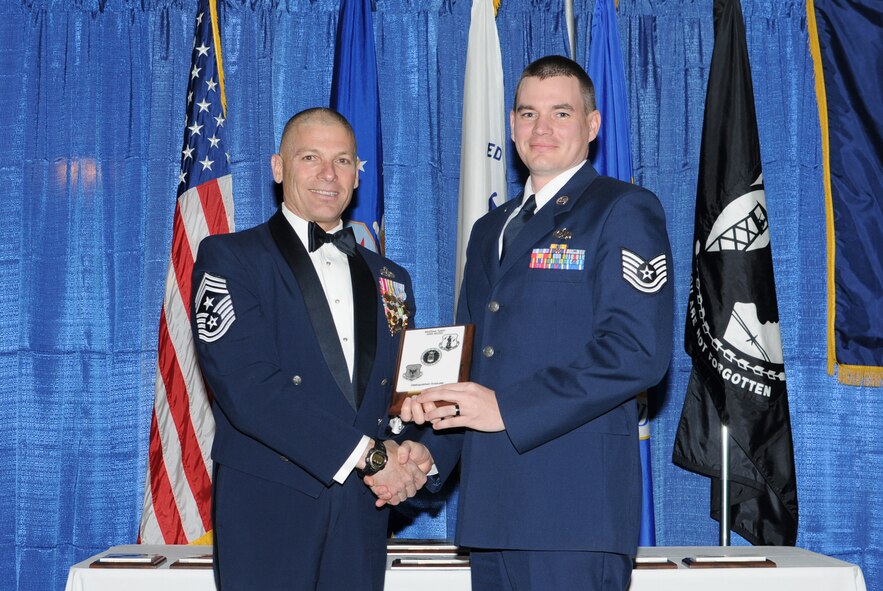 McGHEE TYSON AIR NATIONAL GUARD BASE, Tenn. -- Tech. Sgt. Michael R. Nakoski, right, the assistant inspection section chief for the 9th Maintenance Squadron, Beale AFB, Calif., receives the distinguished graduate award for NCO Academy Class 10-3 at The I.G. Brown Air National Guard Training and Education Center here from Chief Master Sgt. James E. Downing, Sr., Feb. 11, 2010.   The distinguished graduate award is presented to students in the top ten percent of the class.  It is based on objective and performance evaluations, demonstrated leadership, and performance as a team player. (U.S. Air Force photo by Master Sgt. Kurt Skoglund/Released)
