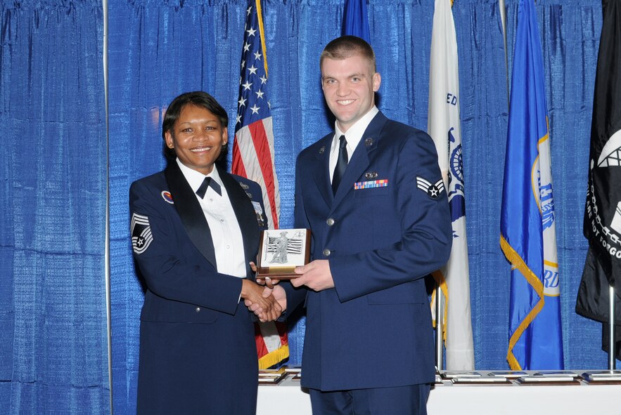 McGHEE TYSON AIR NATIONAL GUARD BASE, Tenn. -- Senior Airman Kyle K. Sunne, right, an electrician with the 934th Civil Engineering Squadron at the St. Paul, Minn., Air Force Reserve Station, receives the academic achievement award for Airman Leadership School Class 10-1 at The I.G. Brown Air National Guard Training and Education Center here from Chief Master Sgt. Deborah Davidson, Feb. 11, 2010.  The academic achievement award denotes excellence as a scholar.  It is based upon all summative objective tests and individual performance evaluations and is given to the student with the highest overall academic standing.   (U.S. Air Force photo by Master Sgt. Kurt Skoglund/Released)