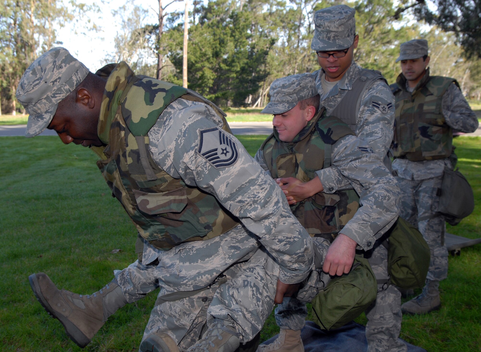 VANDENBERG AIR FORCE BASE, Calif. -- Using a two-man carry, members of Team Vandenberg demonstrate how to carry a wounded Airman during a North Star exercise at Cocheo Park here Thursday, Feb. 10, 2010. North Star is used to test each Airman's knowledge of self-aid and buddy care, force protection levels, terrorist attacks and many other situations that may arise in a deployed location. (U.S. Air Force photo/Airman 1st Class Kerelin Molina)