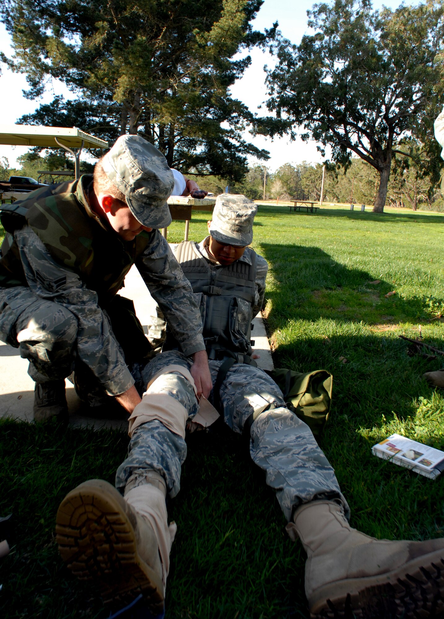 VANDENBERG AIR FORCE BASE, Calif. -- Airman 1st Class Douglas Rossmiller, a member of  the 798th Munitions Maintenance Group, applies a pressure bandage to Airman 1st Class  Mychal Oliver, a member of the 576th Flight Test Squadron, during self-aid and buddy care training Thursday, Feb. 10, 2010 at Cocheo Park here during a North Star exercise. North Star's overall objective is to provide tasked personnel pre-deployment training similar to that normally received before supporting a deployment tasking. (U.S. Air Force photo/Airman 1st Class Kerelin Molina)