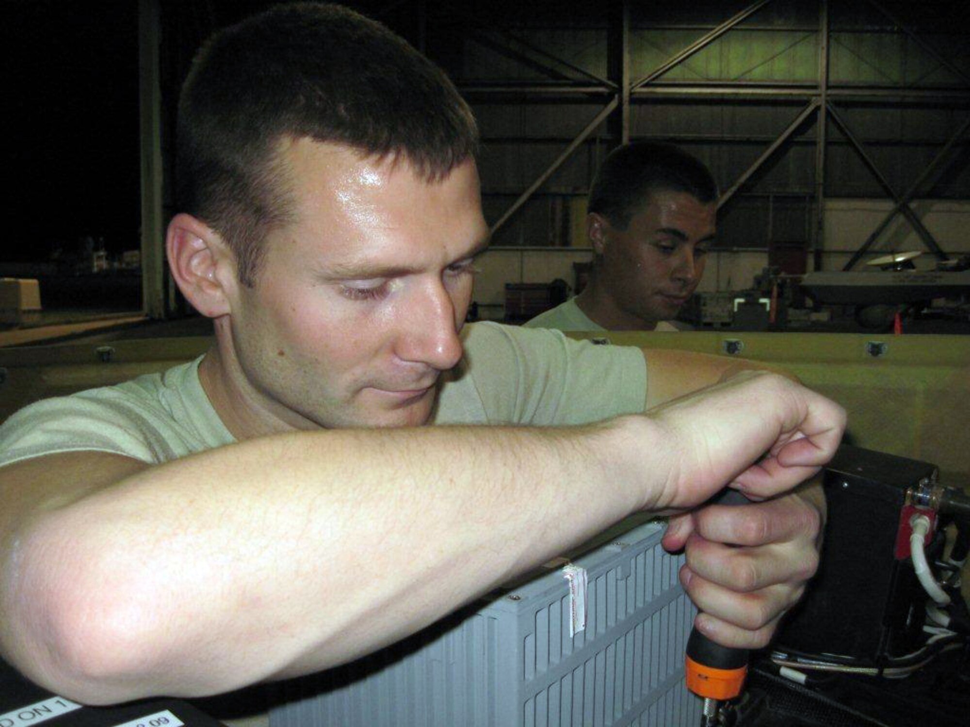 Staff Sgt. Jake Gauvin installs a multisensor tactical system turret on an RQ-1 Predator in support of Operation Unified Response Feb. 9, 2010, at Holloman Air Force Base, N.M. Members from the 849th Aircraft Maintenance Squadron teamed up with members of the 432nd Air Expeditionary Wing from Creech AFB, Nev., to provide support to troops on the ground in Haiti. Sergeant Gauvin is a member of the 849th AMXS at Holloman Air Force Base, N.M. (Courtesy photo)
