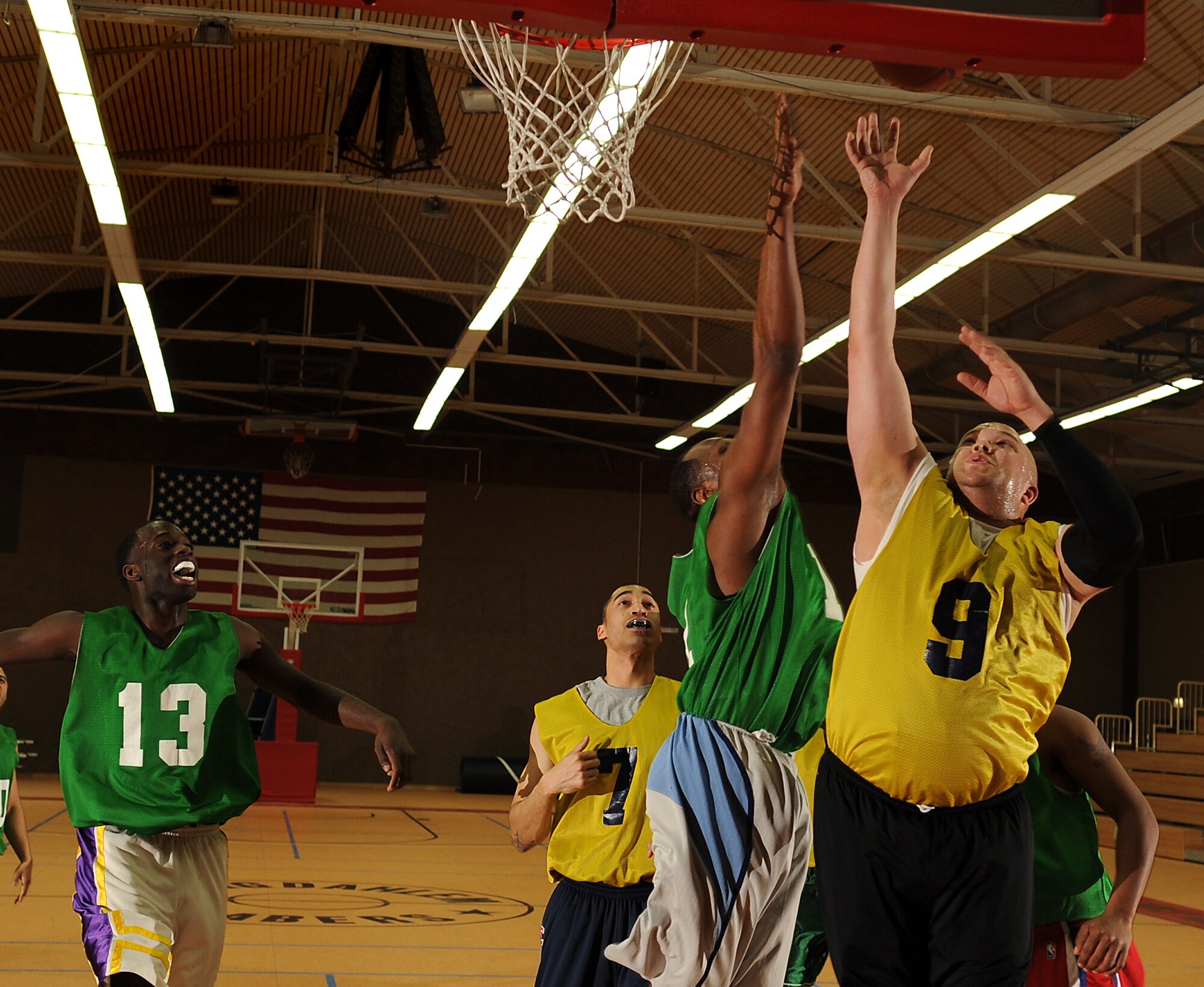 SPANGDAHLEM AIR BASE, Germany – Tech. Sgt. Damon Henderson, right, 52nd Security Forces Squadron, shoots a layup during the first game of the intramural basketball championship series here Feb. 11. The 52nd Communications Squadron defeated the 52nd SFS 57-36 in the first game and 73-67 in overtime the second game, winning the championship title. This is the squadron’s third consecutive championship title. (U.S. Air Force photo/Senior Airman Nathanael Callon)
