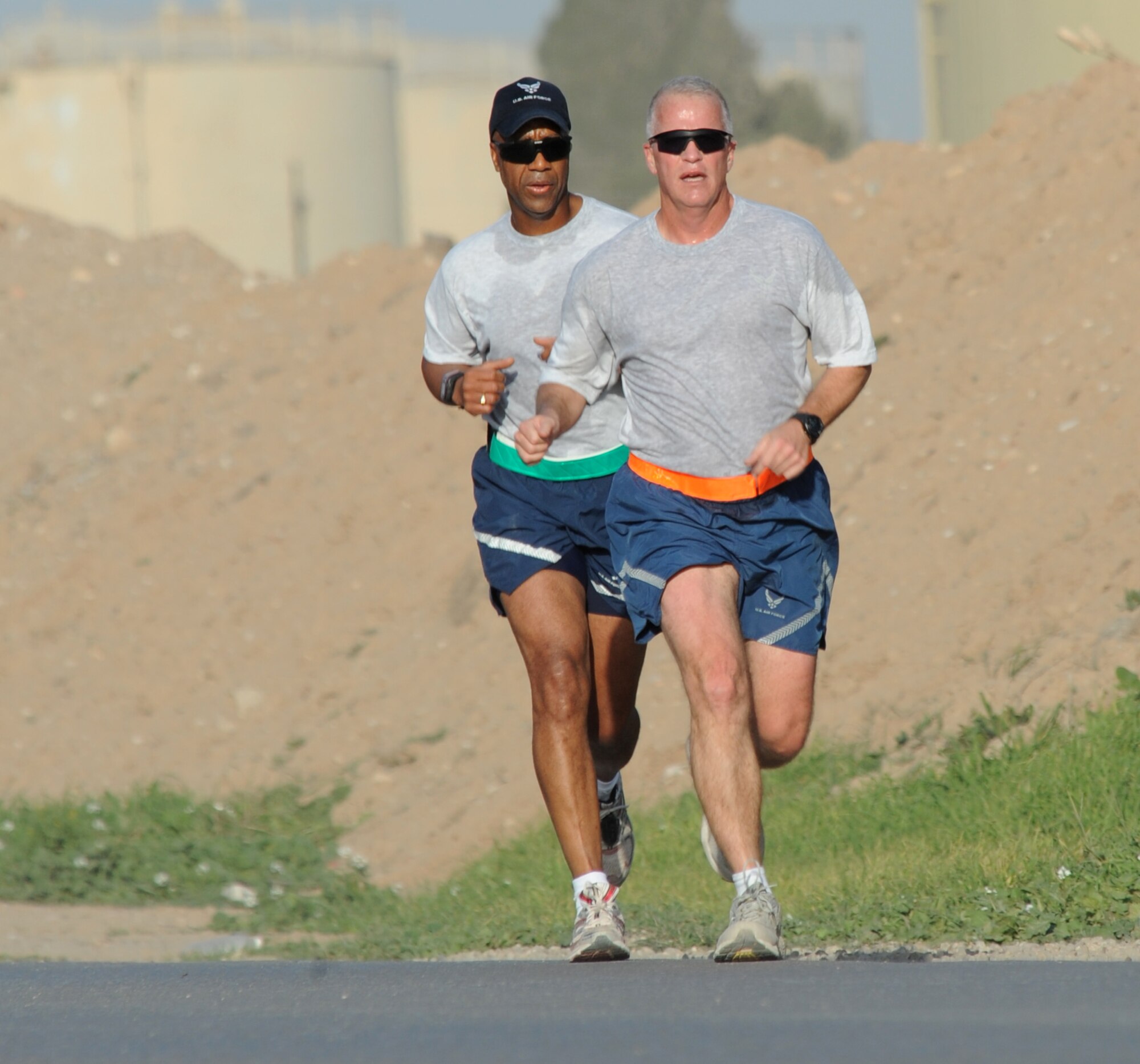 KIRKUK REGIONAL AIR BASE, Iraq – Maj. David Walter, 506th Expeditionary Civil Engineer Squadron commander, and Master Sgt. Jon Conway, 506th ECES first sergeant, take their daily run Feb. 10, 2010.  This duo has run more than 600 miles together since arriving on base, and look forward to reaching their goal of 700 miles before their departure next month. Major Walter and Sergeant Conway are deployed from McChord AFB, Wash., where both serve in the Reserves as commander and first sergeant for the 446th CES.  (U.S. Air Force photo/Staff Sgt. Tabitha Kuykendall)