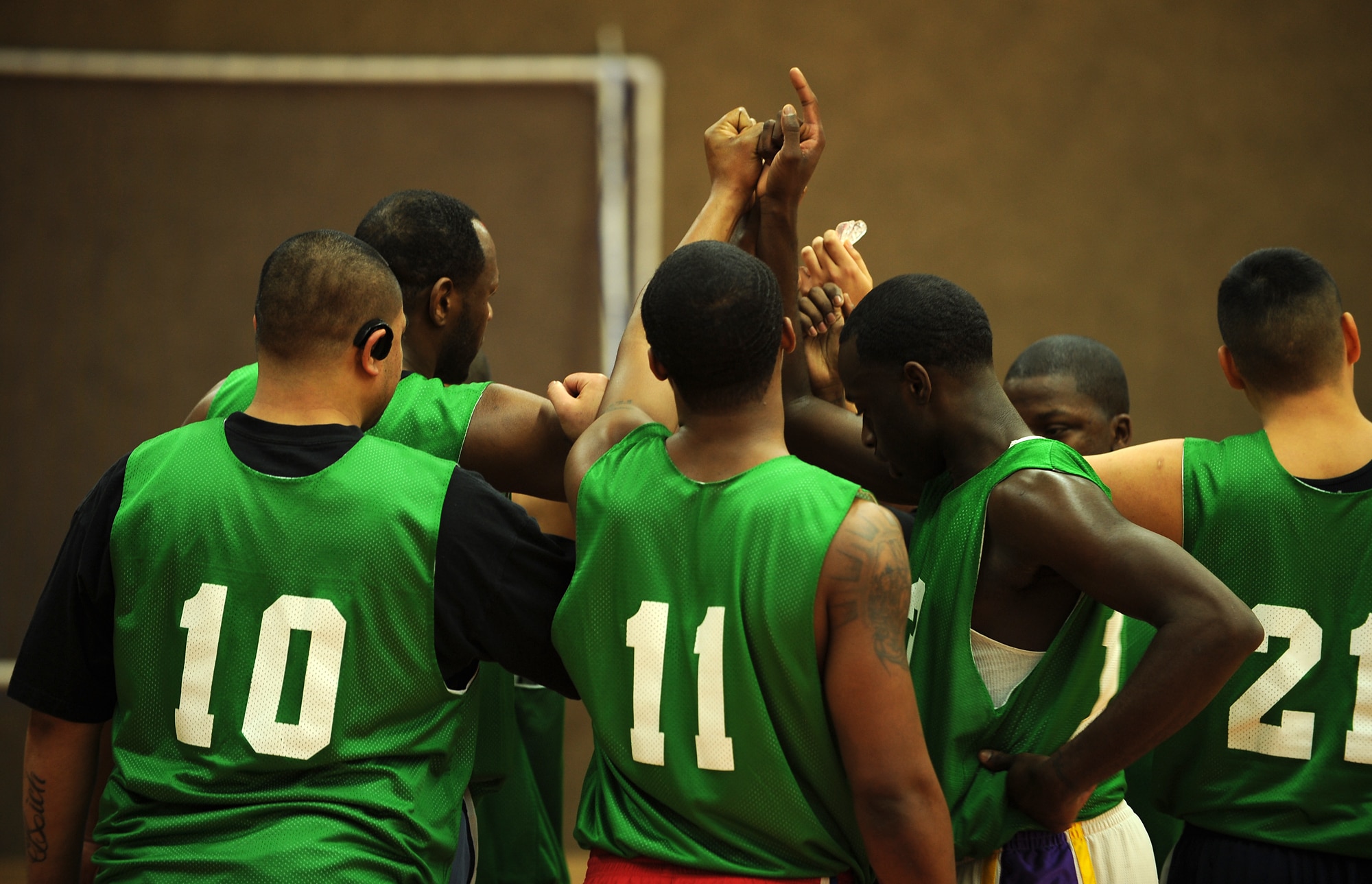 SPANGDAHLEM AIR BASE, Germany – Members of the 52nd Communications Squadron basketball team rally during a timeout during the first game of the intramural basketball championship series here Feb. 11. The 52nd CS defeated the 52nd Security Forces Squadron 57-36 in the first game and 73-67 in overtime the second game, winning the championship title. This is the squadron’s third consecutive championship title. (U.S. Air Force photo/Senior Airman Nathanael Callon)