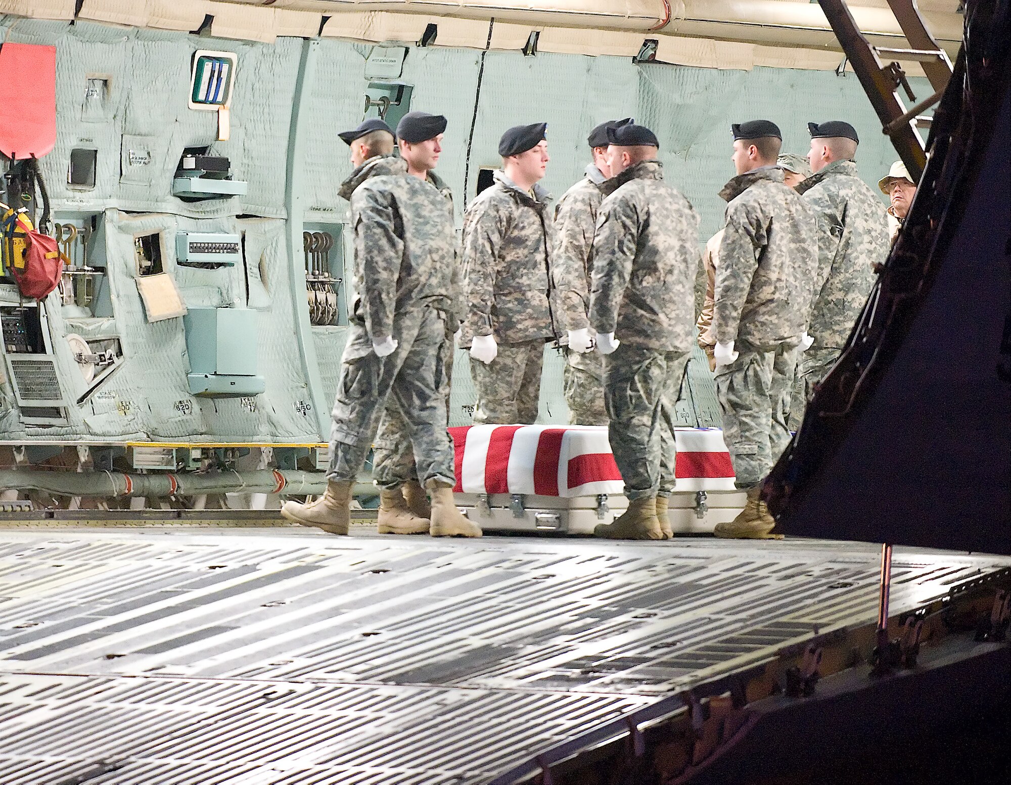 A U.S. Army carry team transfers the remains of Army SPC Adam J. Ray of Louisville, K.Y., at Dover Air Force Base, Del., on February 12, 2010. (U.S. Air Force photo/Brianne Zimny. SPC Ray was pf tje 4th Battalion, 23rd Infantry, 2BCT of Ft Lewis, W.A.