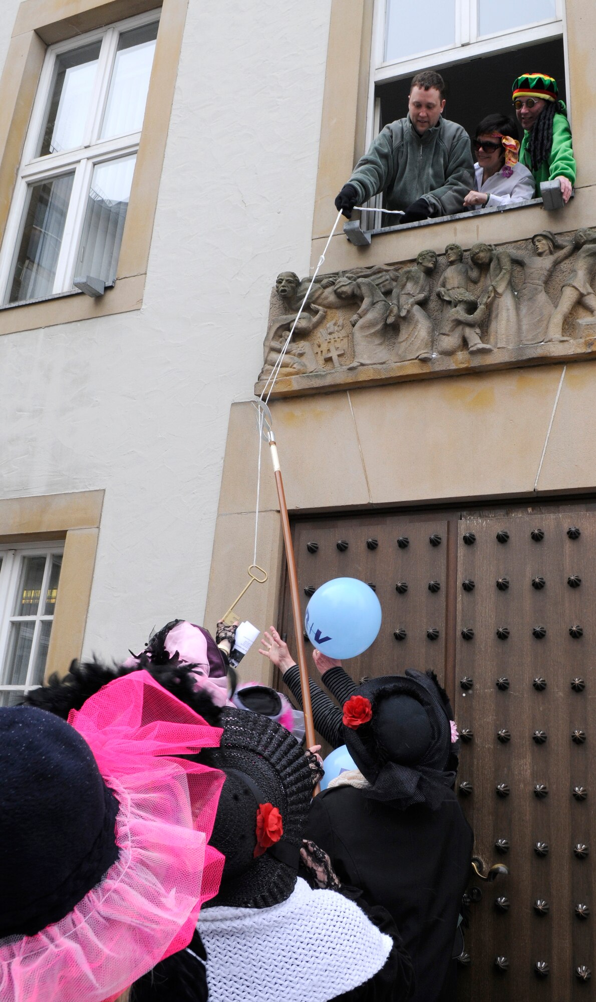 SPANGDAHLEM AIR BASE, Germany – Maj. David Eisenach, 52nd Medical Group, loses control of the symbolic key to the women of Bitburg during the annual storming of the Rathaus, or town hall, Feb. 11. Major Eisenach and several other 52nd Fighter Wing members took part in the celebration and assisted Joachim Kandels, Bitburg mayor, in defending the key. Once the women got the key, they also took control of the city for the rest of the day. The storming marks Weiberdonnerstag, or the first day of Fasching. (U.S. Air Force photo/Airman 1st Class Staci Miller)