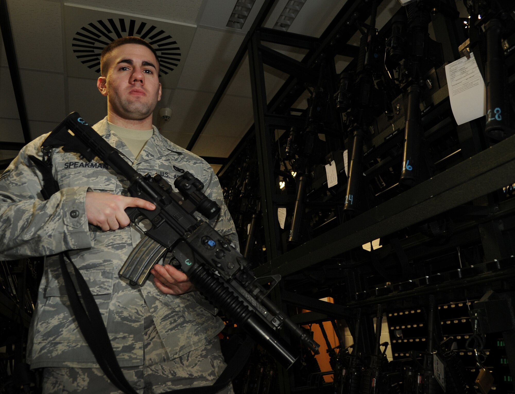 U.S. Air Force Airman 1st Class Gregory Speakman, 86th Security Forces Squadron armors, poses for a photo with an M-203 rifle while on duty, Ramstein Air Base, Germany, Feb. 09, 2010. The armory personnel services 26 posts during the shift for weapons issue, gear and check-in. (U.S. Air Force photo by Airman 1st Class Caleb Pierce)